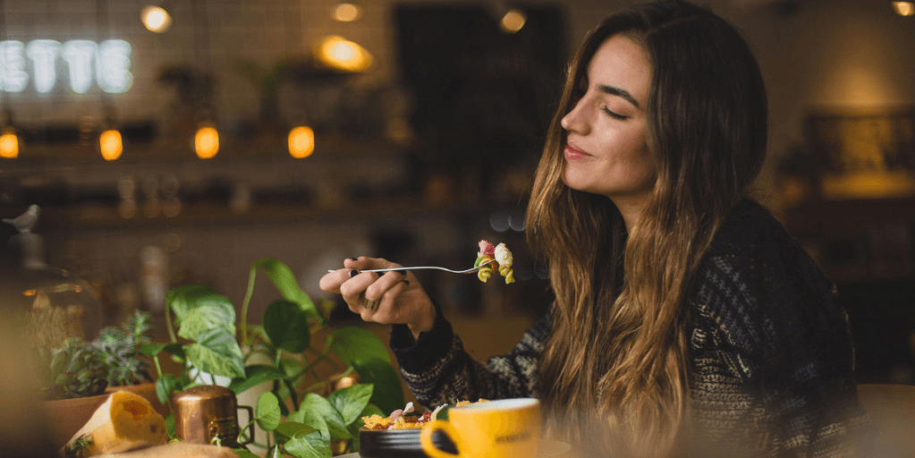 Lady eating food at restaurant