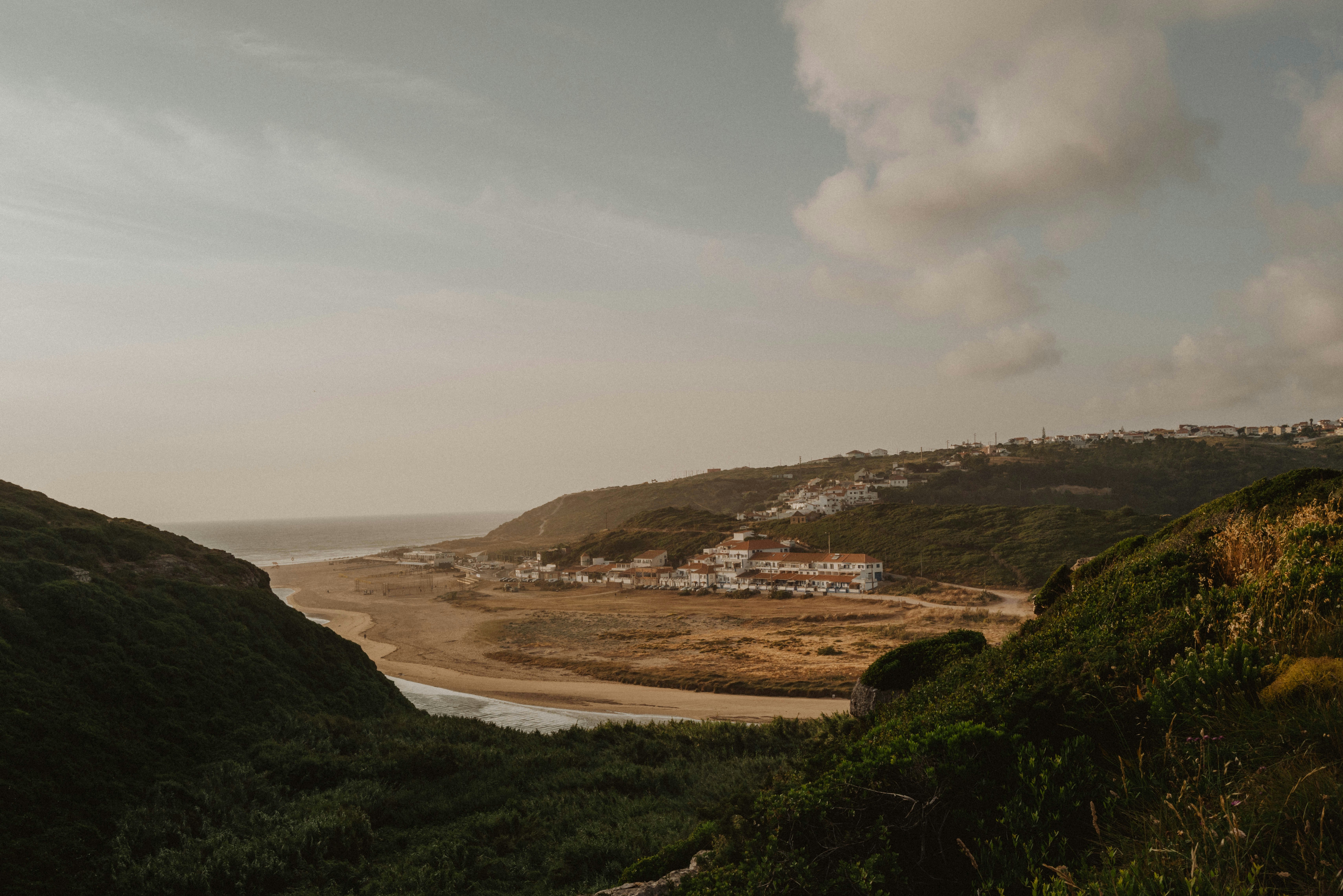 A scenic view of a town by the coast.