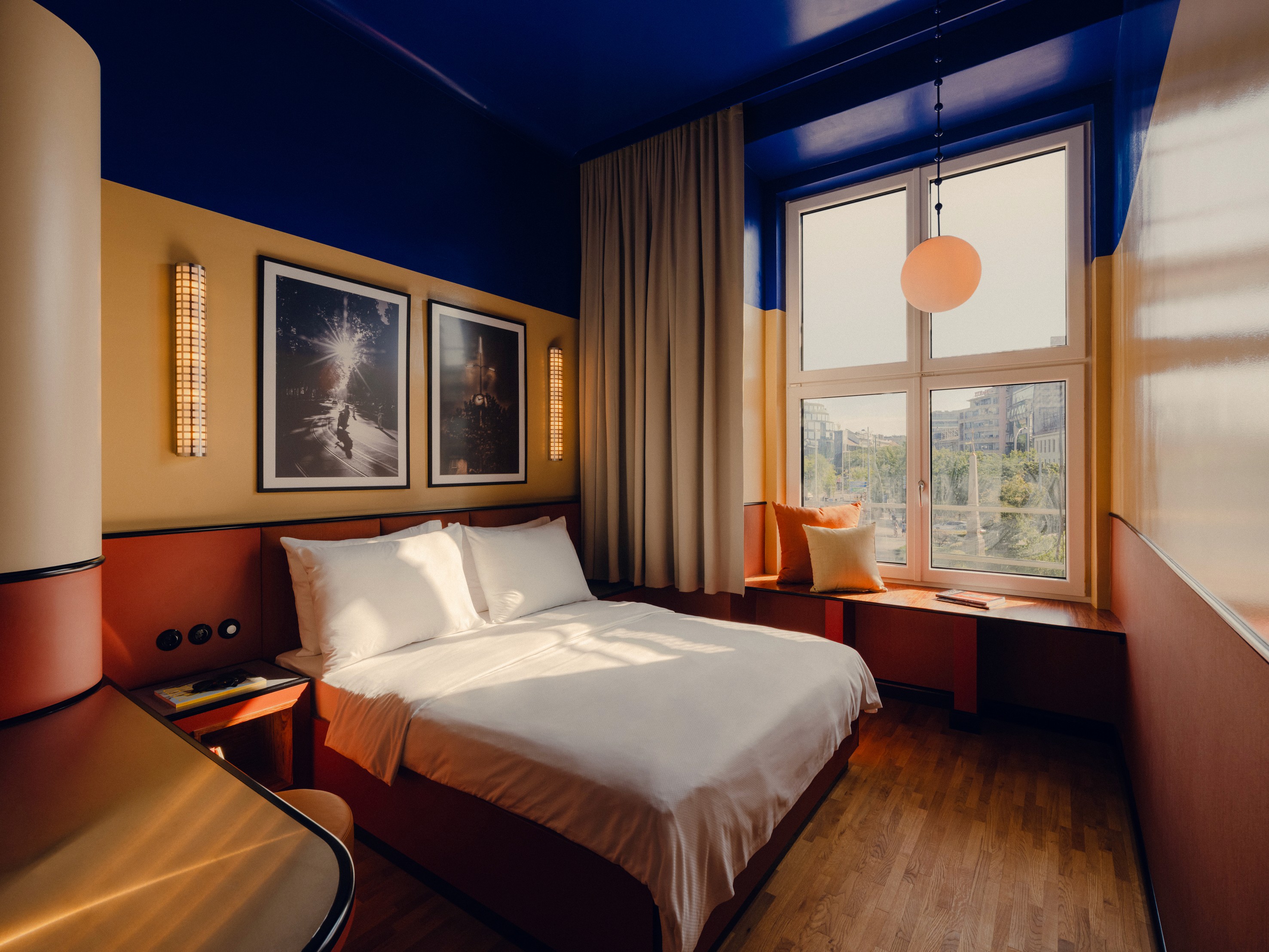 View of the Bed and Window at the Poet M room at The Companion Vienna