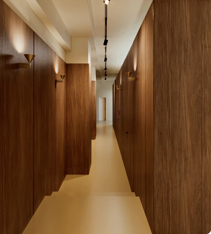 Portrait of a woman stretching her arms, softly lit, conveying calm, vitality, and wellbeing.