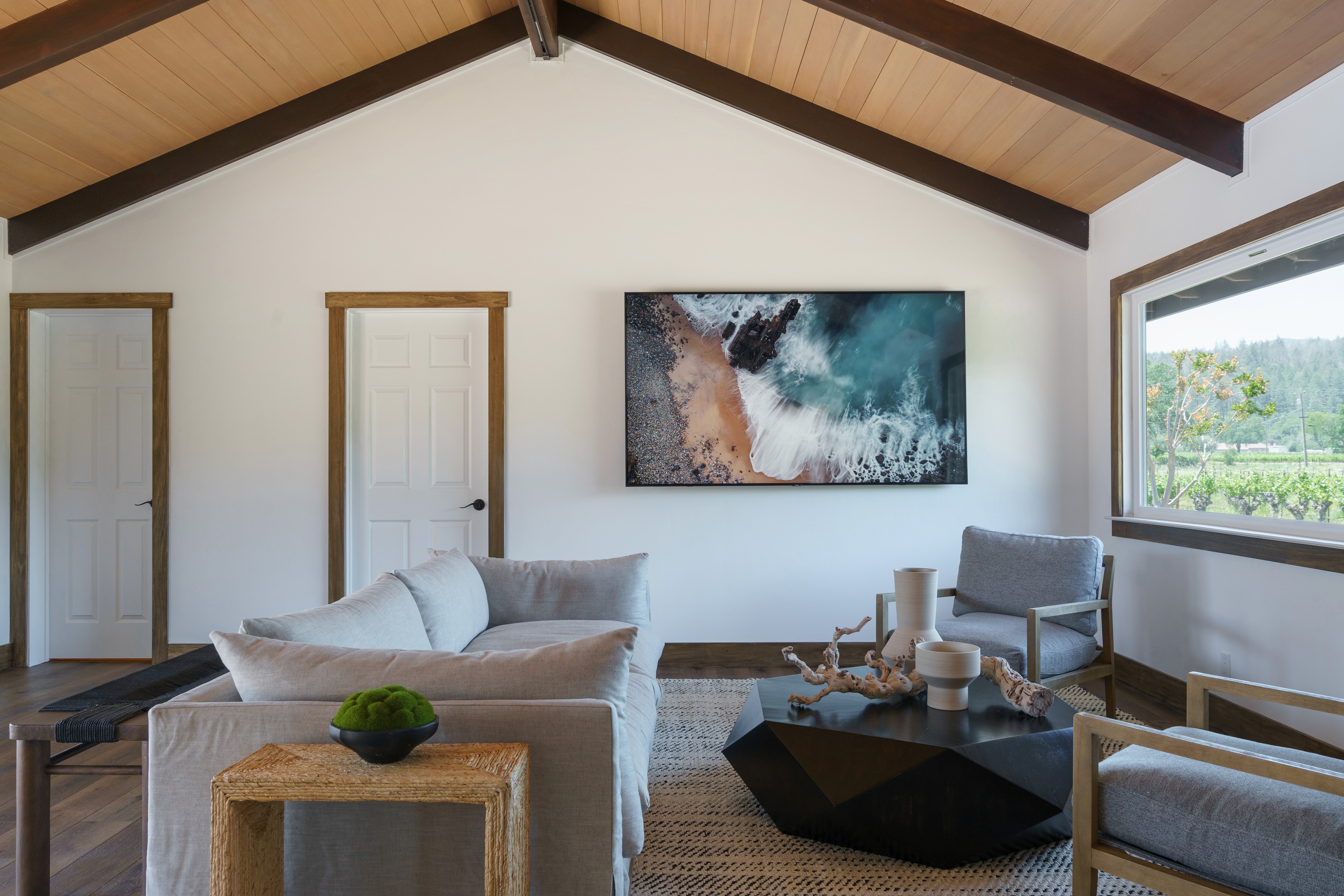 This beautifully landscaped outdoor space features a cozy patio, stylish dining set, and an eight-person wooden table, perfect for relaxation and entertaining