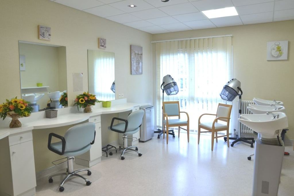 Hair salon with styling chairs mirrors professional equipment and bright lighting