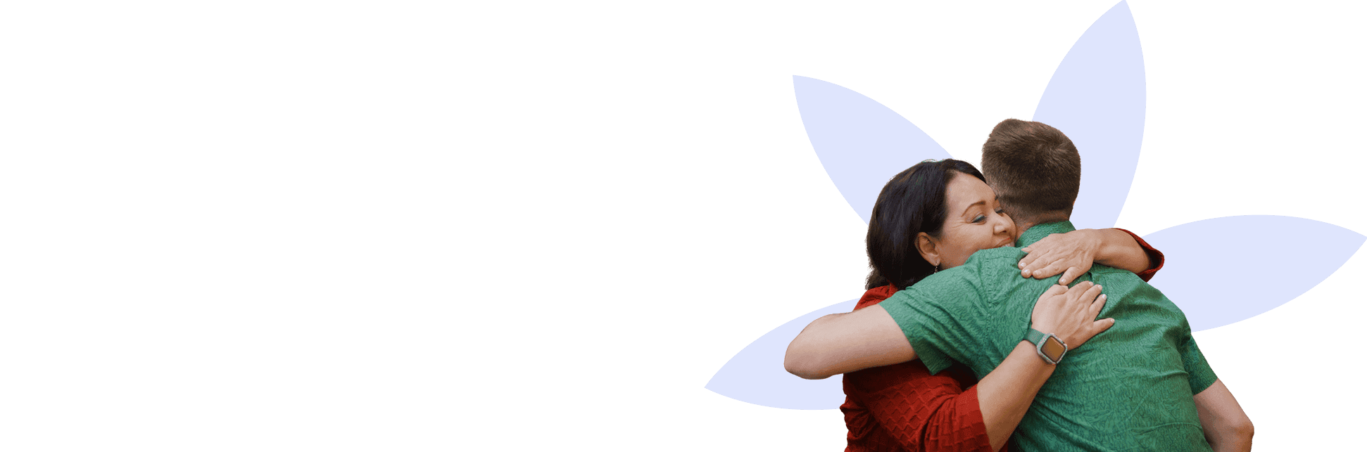 A woman with dark hair wearing a red top embraces a man in a green shirt, with both showing affection in front of a white flower-shaped background.