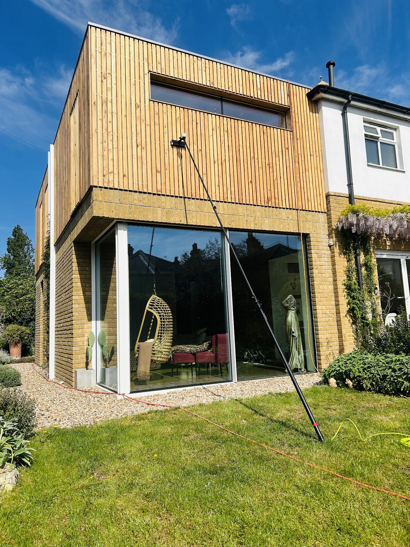 Professional window cleaner working on exterior glass