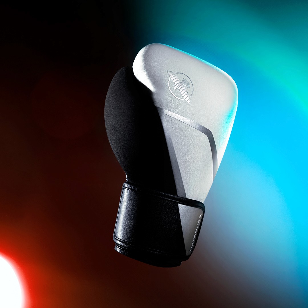 A sleek, green chair with a curved seat and wooden legs, set against a dark green background.