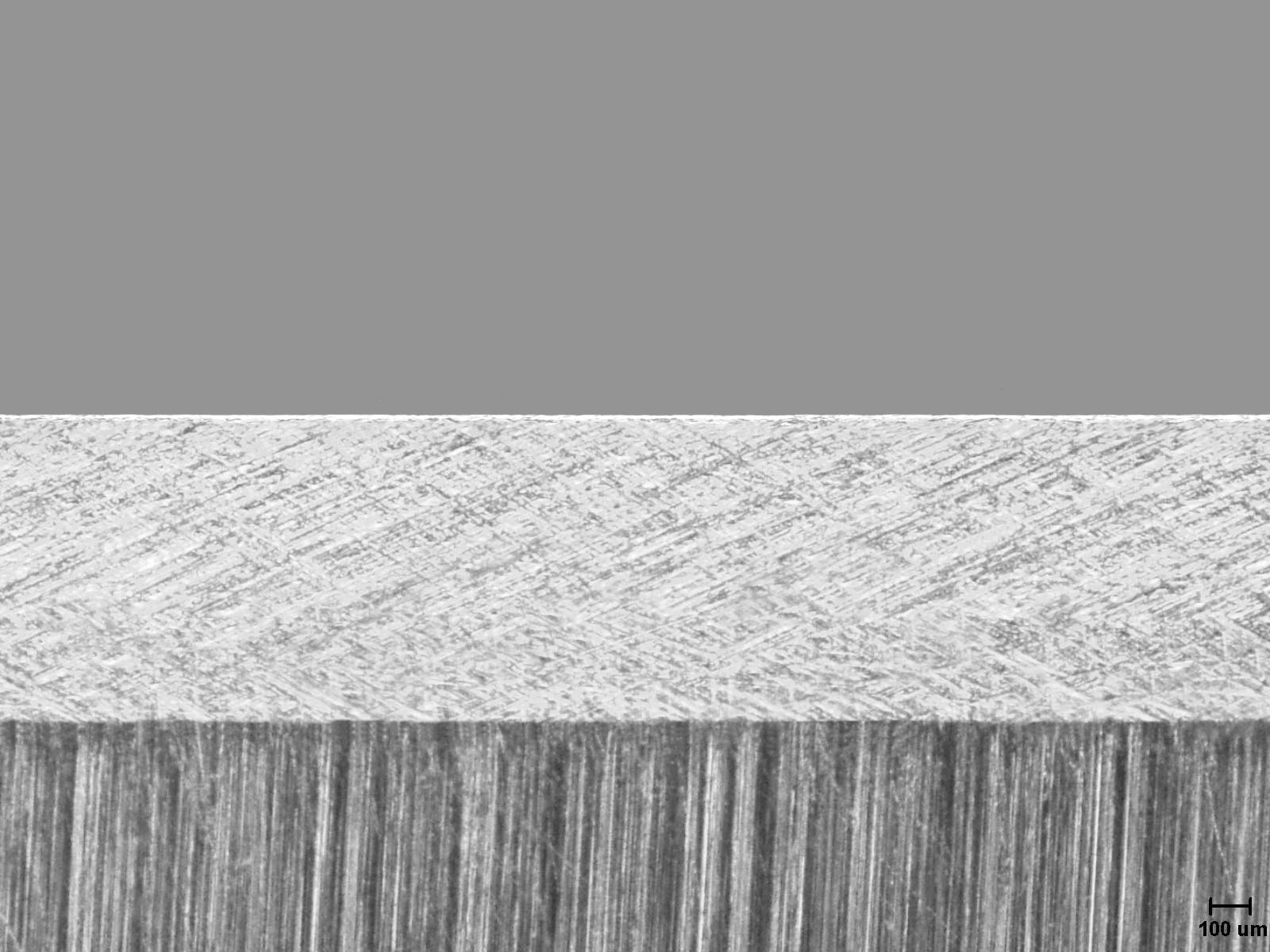 Microscopic view of a polished knife edge after using a leather strop, showing a clean, refined, and razor-sharp finish.