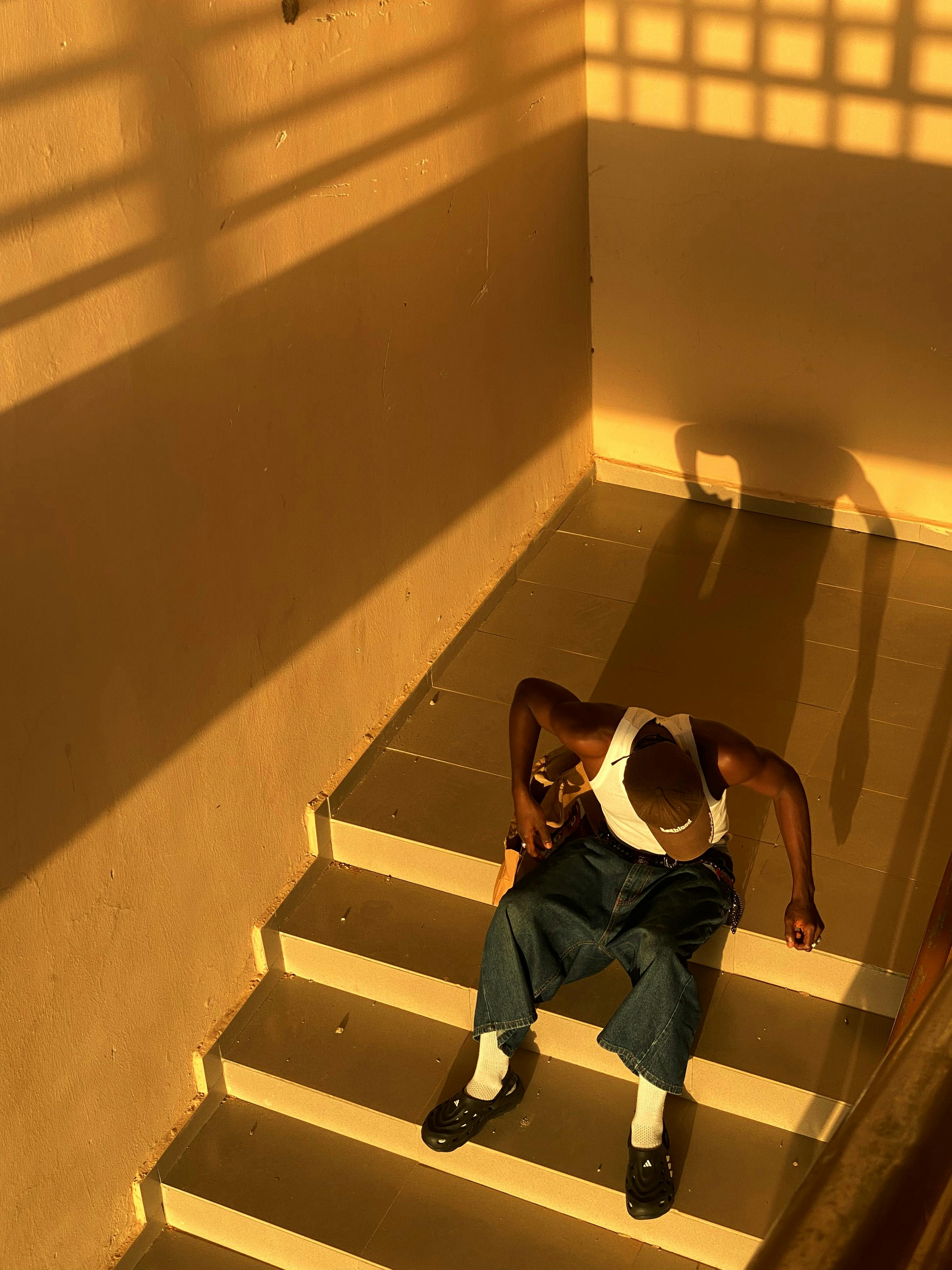 Mani sitting on a staircase