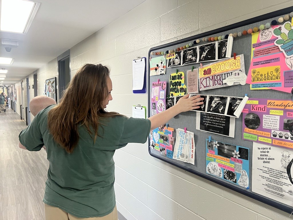 Kaley McDowell reads a quote on a photo board she decorated with inspirational collages, sonogram photos and other crafts. The nursery unit is adorned with motivational quotes and reminders throughout the space.