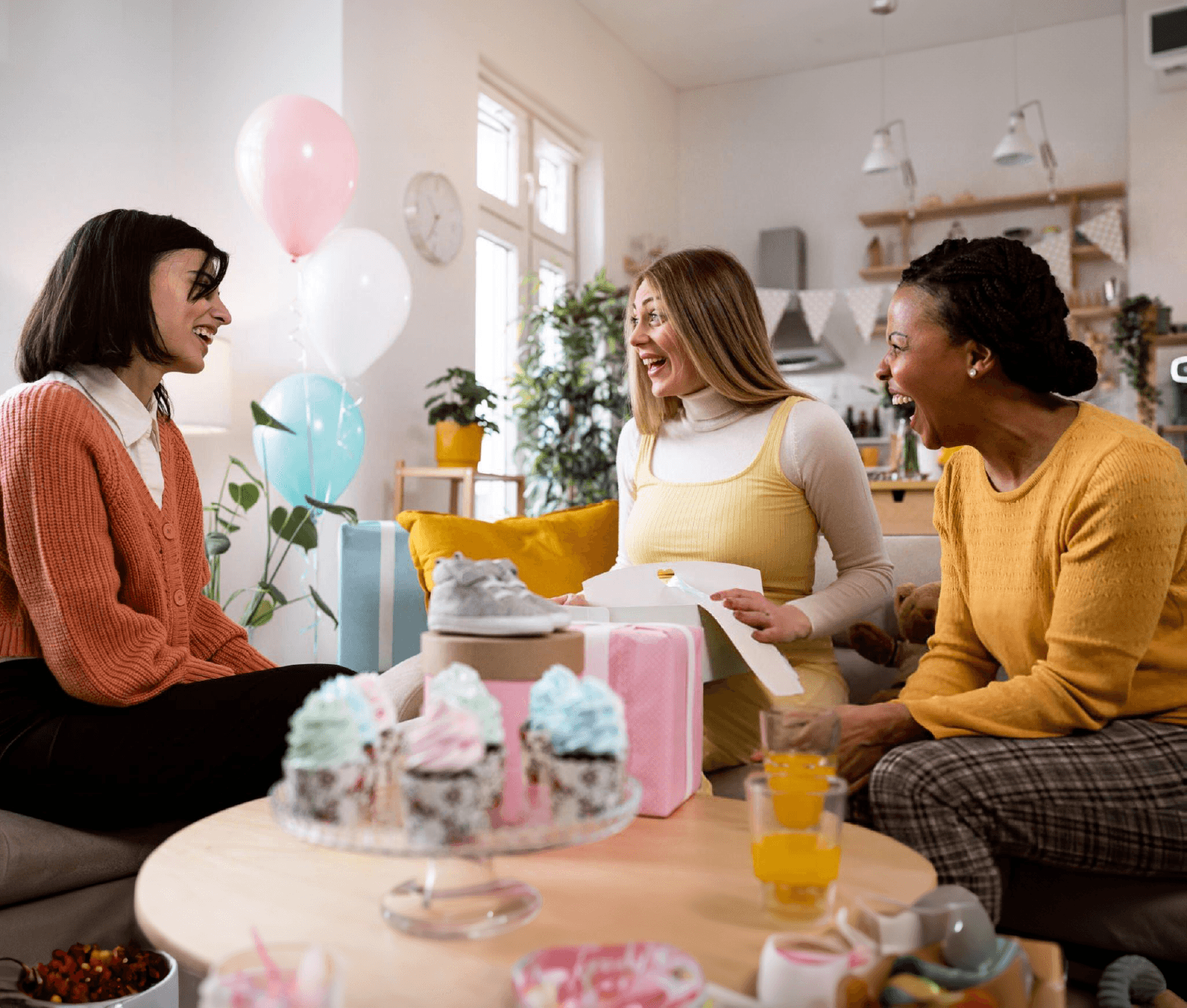 Mãe grávida com suas amigas em casa realizando o seu Chá de Revelação