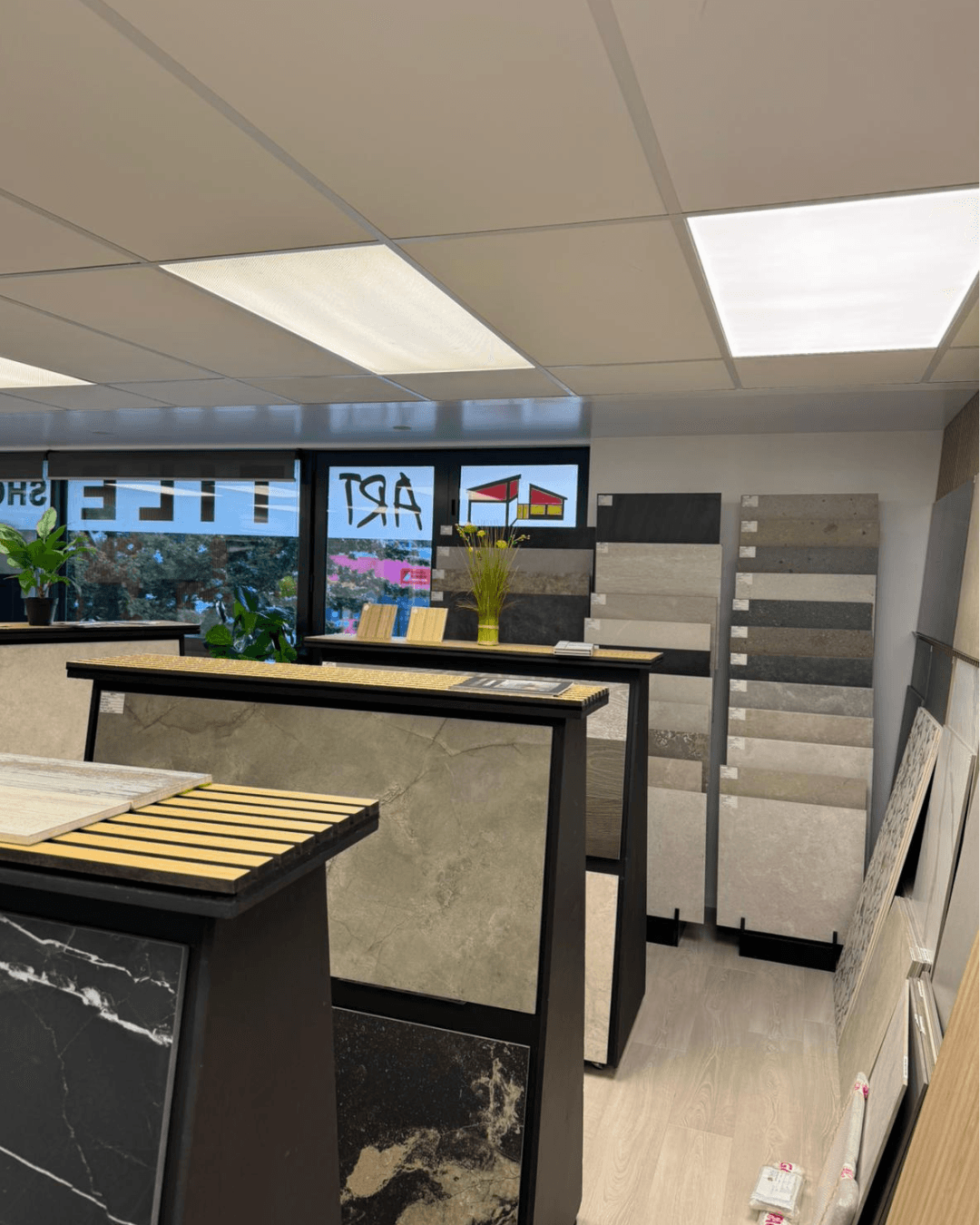 Stylish woman wearing an oversized cream quarter-zip sweatshirt and large sunglasses, looking to the side against a peach-colored wall.