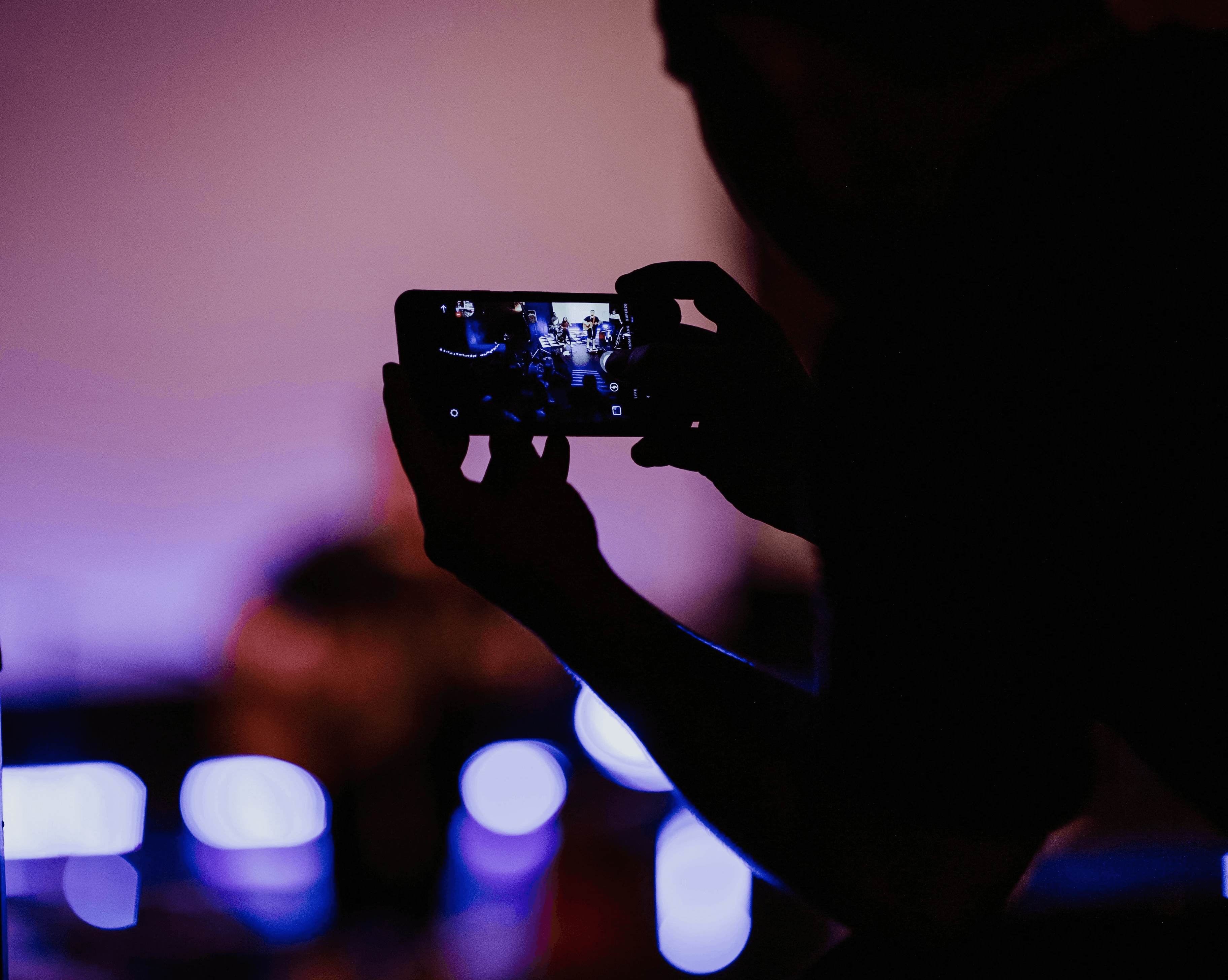 Man filming a party from above Photo by Priscilla Du Preez 🇨🇦 on Unsplash