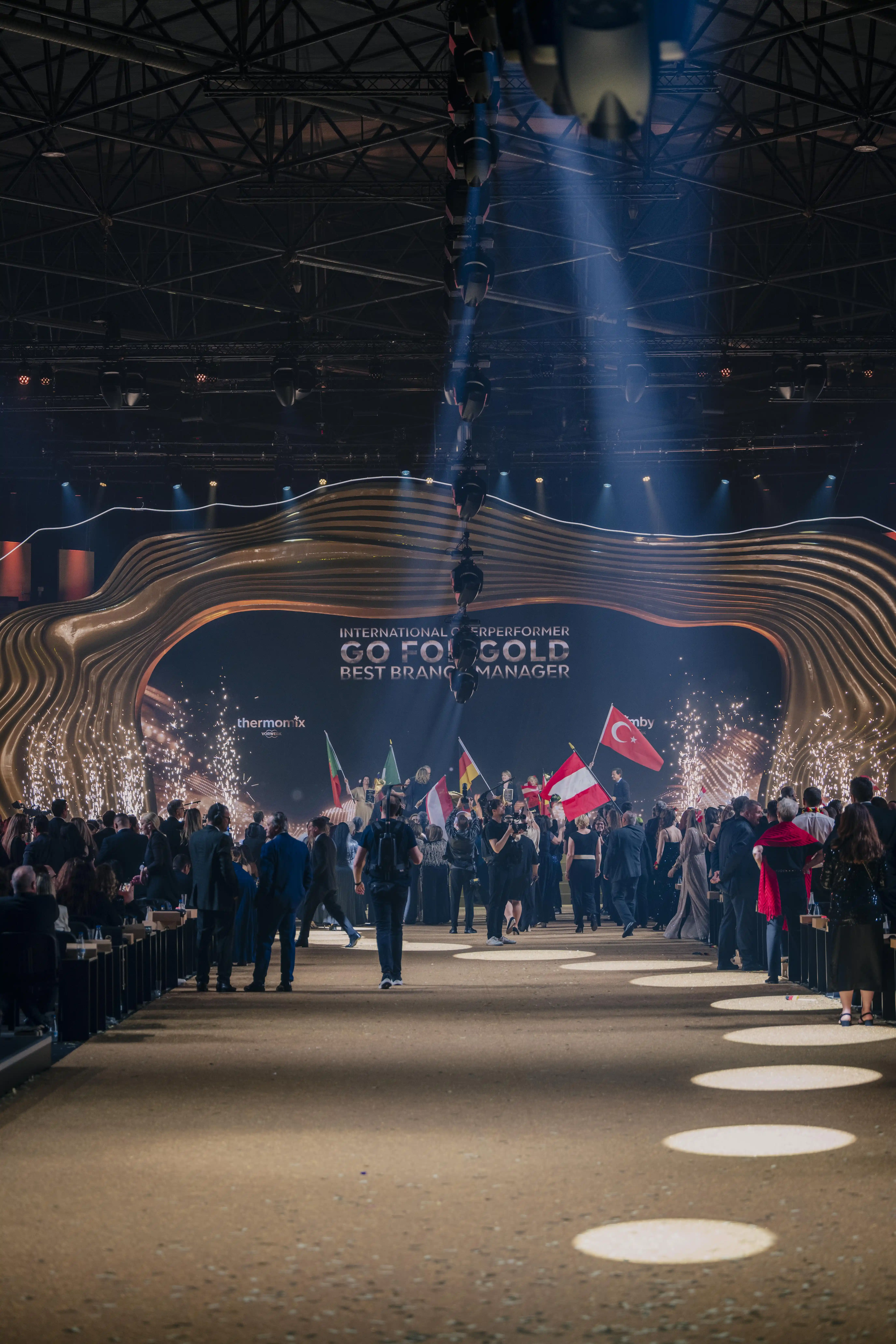 Delegations with national flags marching in at the Go for Gold award show.