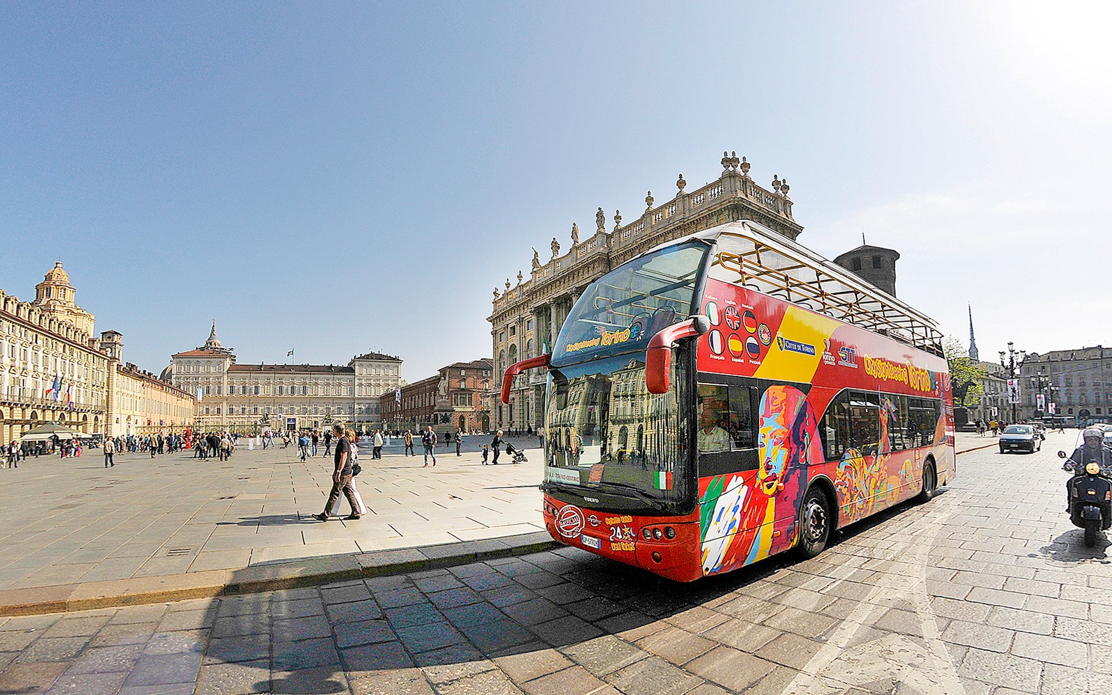 รถบัสนำเที่ยวเปิดหลังคาที่ Piazza Castello, Turin พร้อมกับอาคารประวัติศาสตร์เป็นฉากหลัง