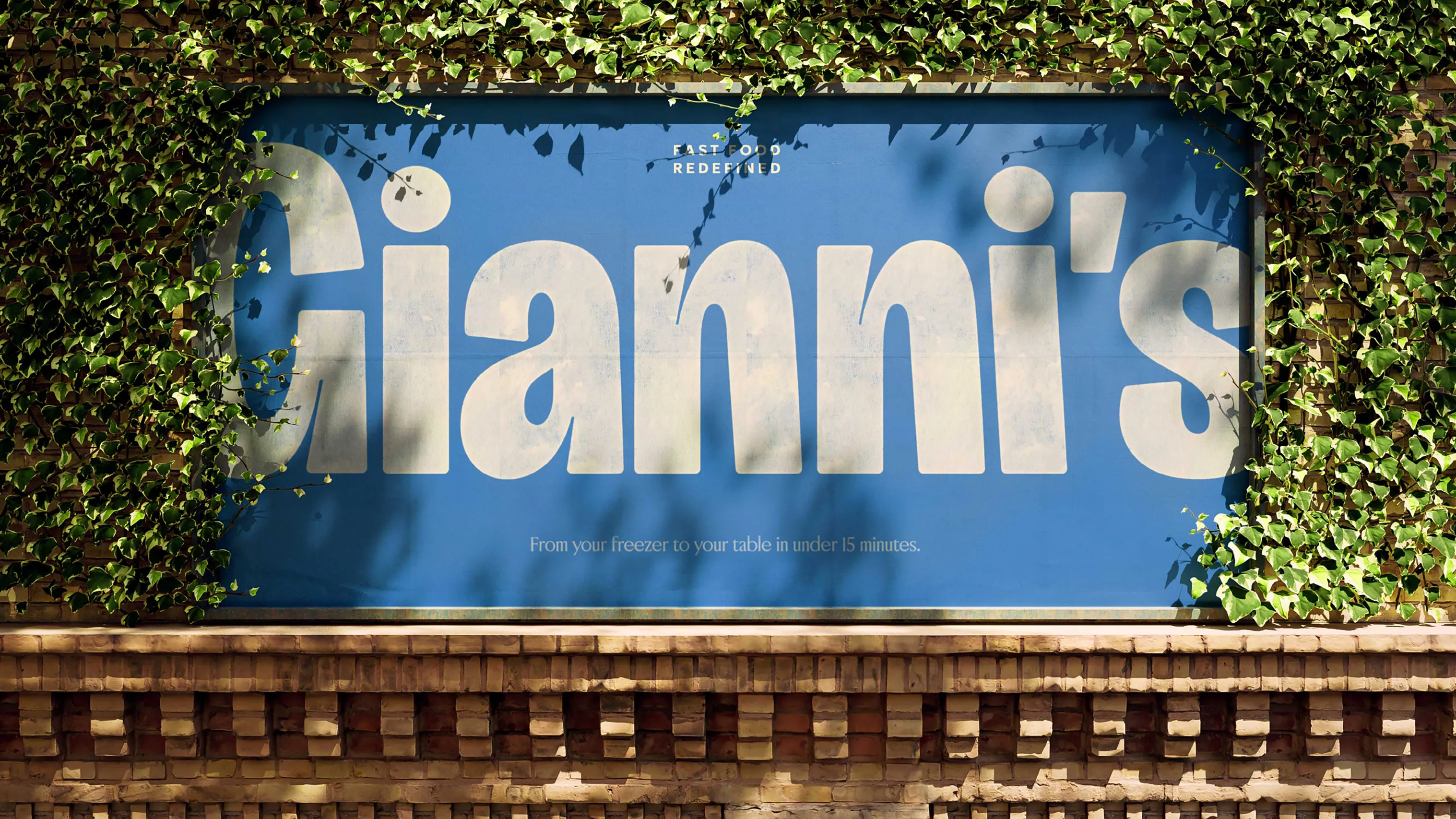 Large Gianni’s wordmark displayed on a blue outdoor sign surrounded by greenery