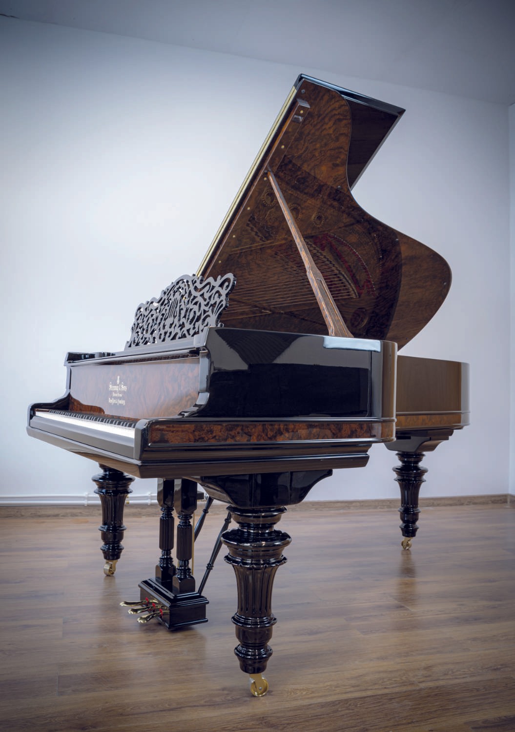 A stunning piano with elegant burl walnut details, combining modern and classical aesthetics.