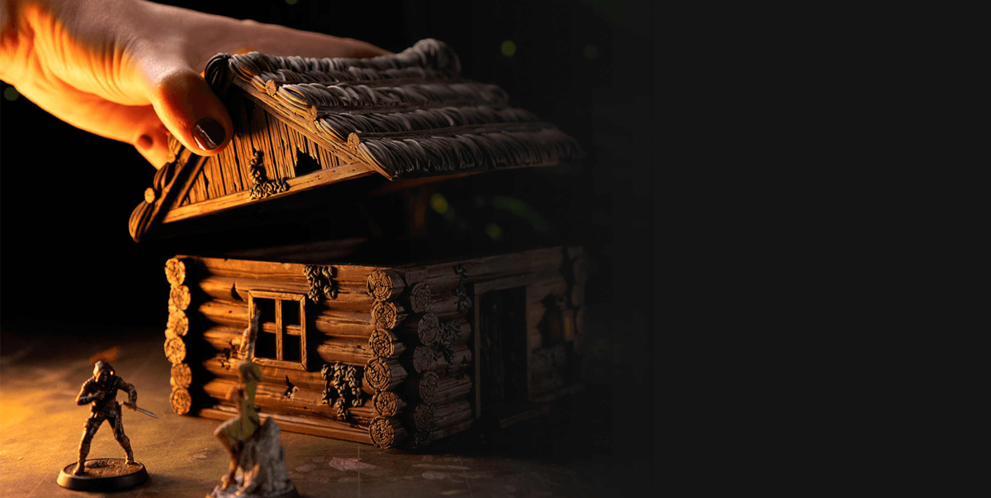 A mini house in the background with two miniatures close to each other