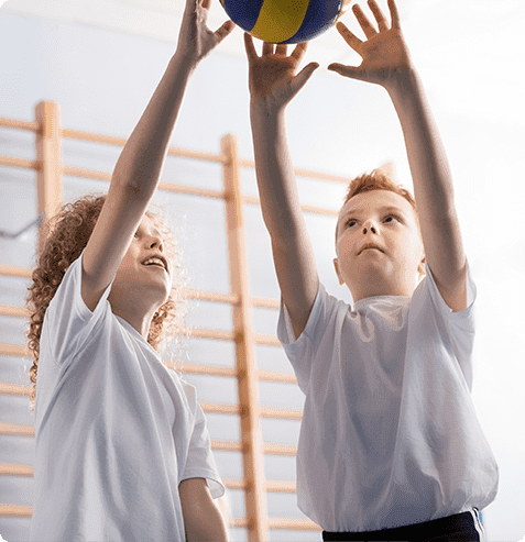 Elementary students playing volleyball during a HOKALI after-school sports program