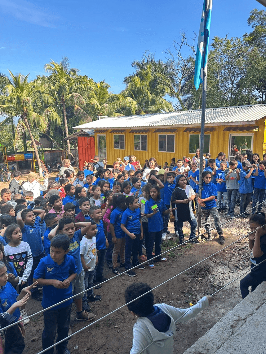 A group of children standing in a line

AI-generated content may be incorrect.