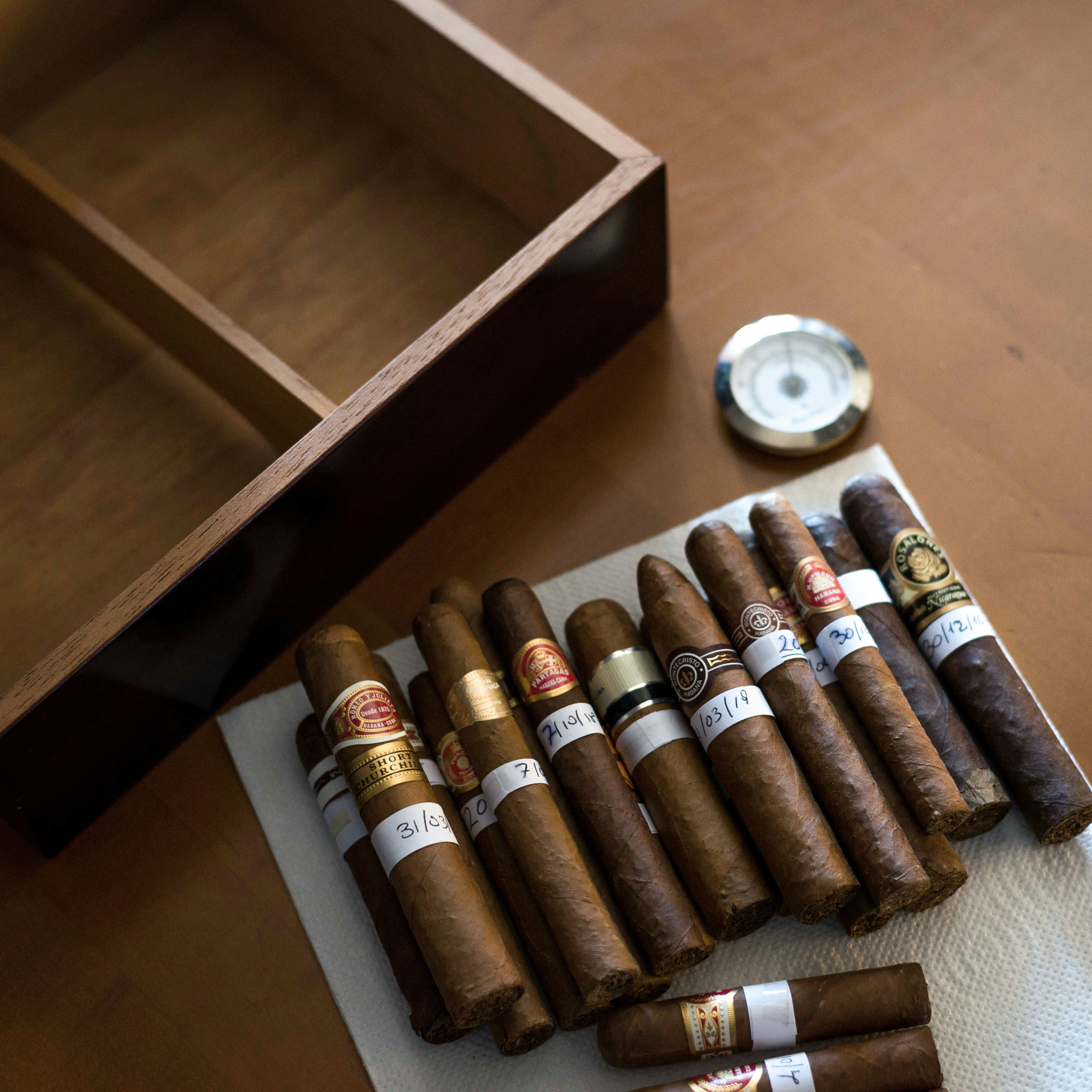 brown and silver tube bottle in brown wooden box