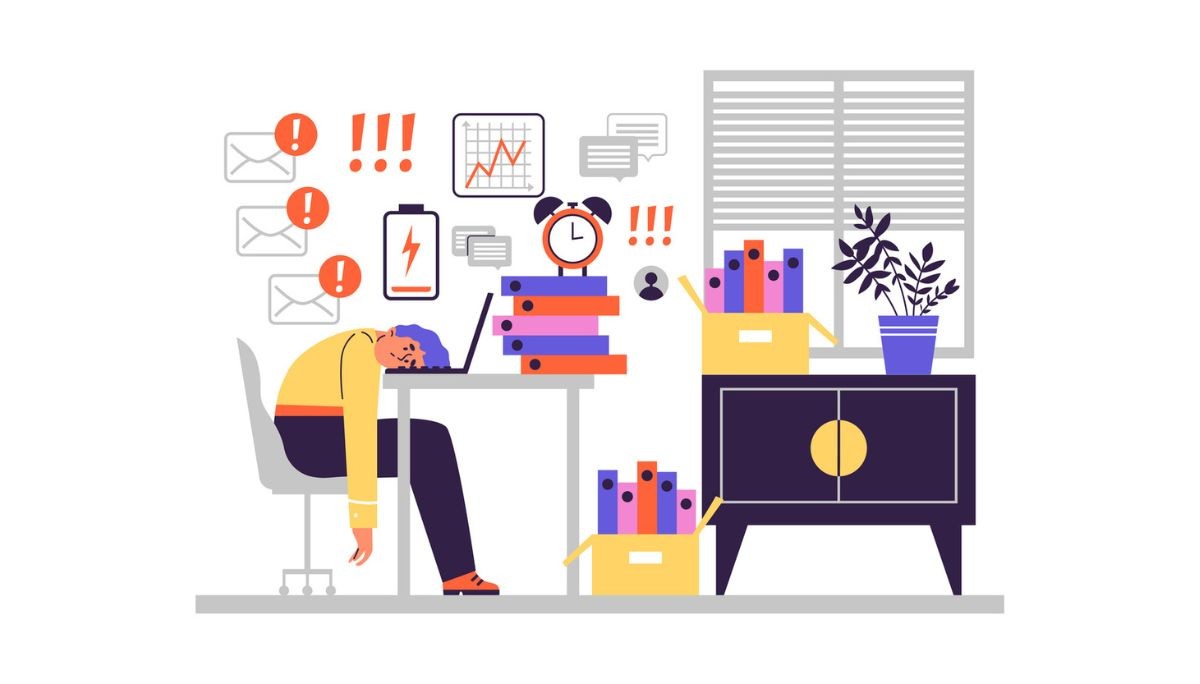 Illustration of an overwhelmed worker slumped over a laptop at a cluttered desk, surrounded by icons of low battery, alerts, deadlines, and rising workload, representing workplace stress and strategies needed to build resilience and focus.
