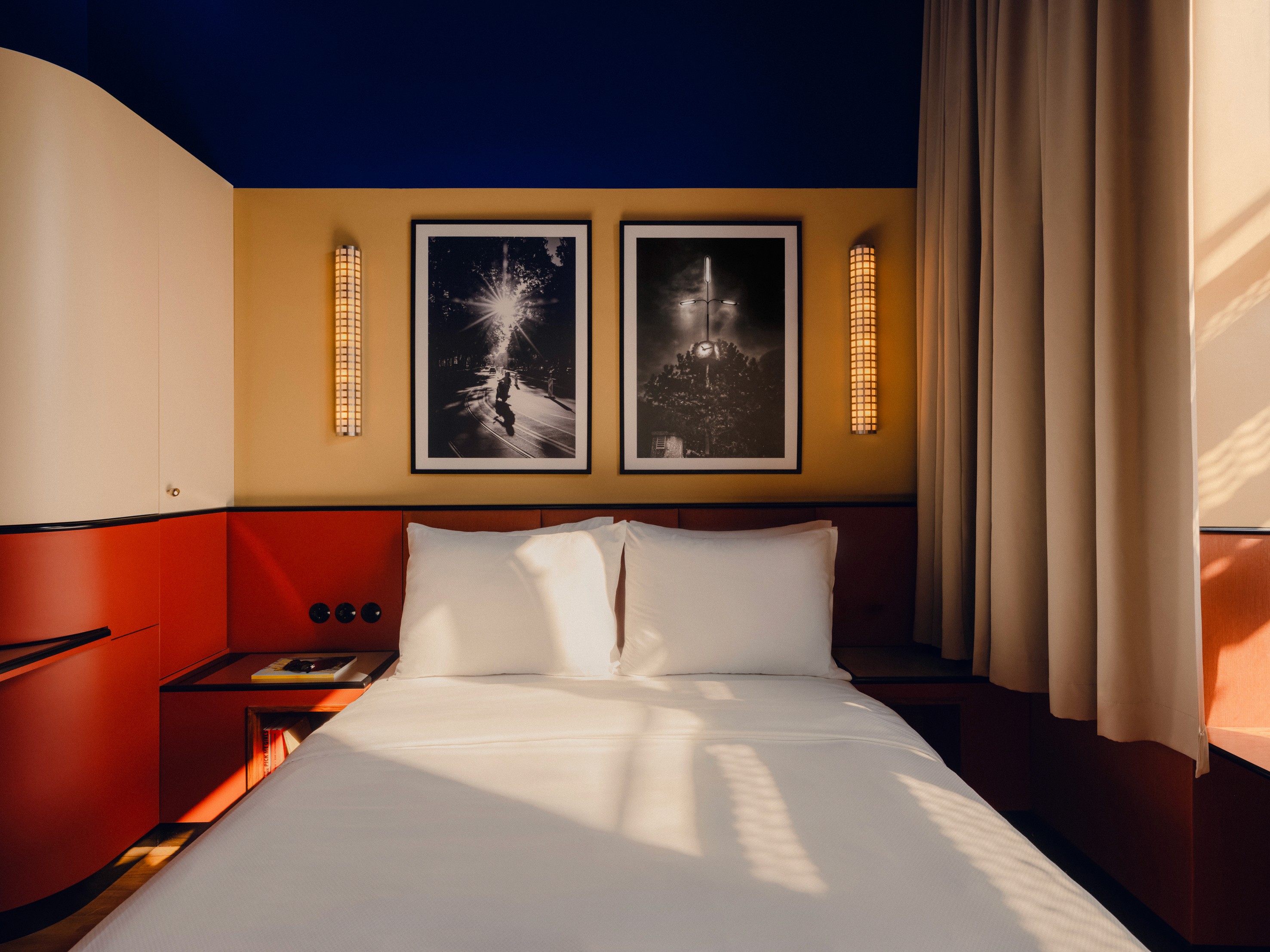 Neatly made bed at "The Nest" hotel room at the Companion Vienna.