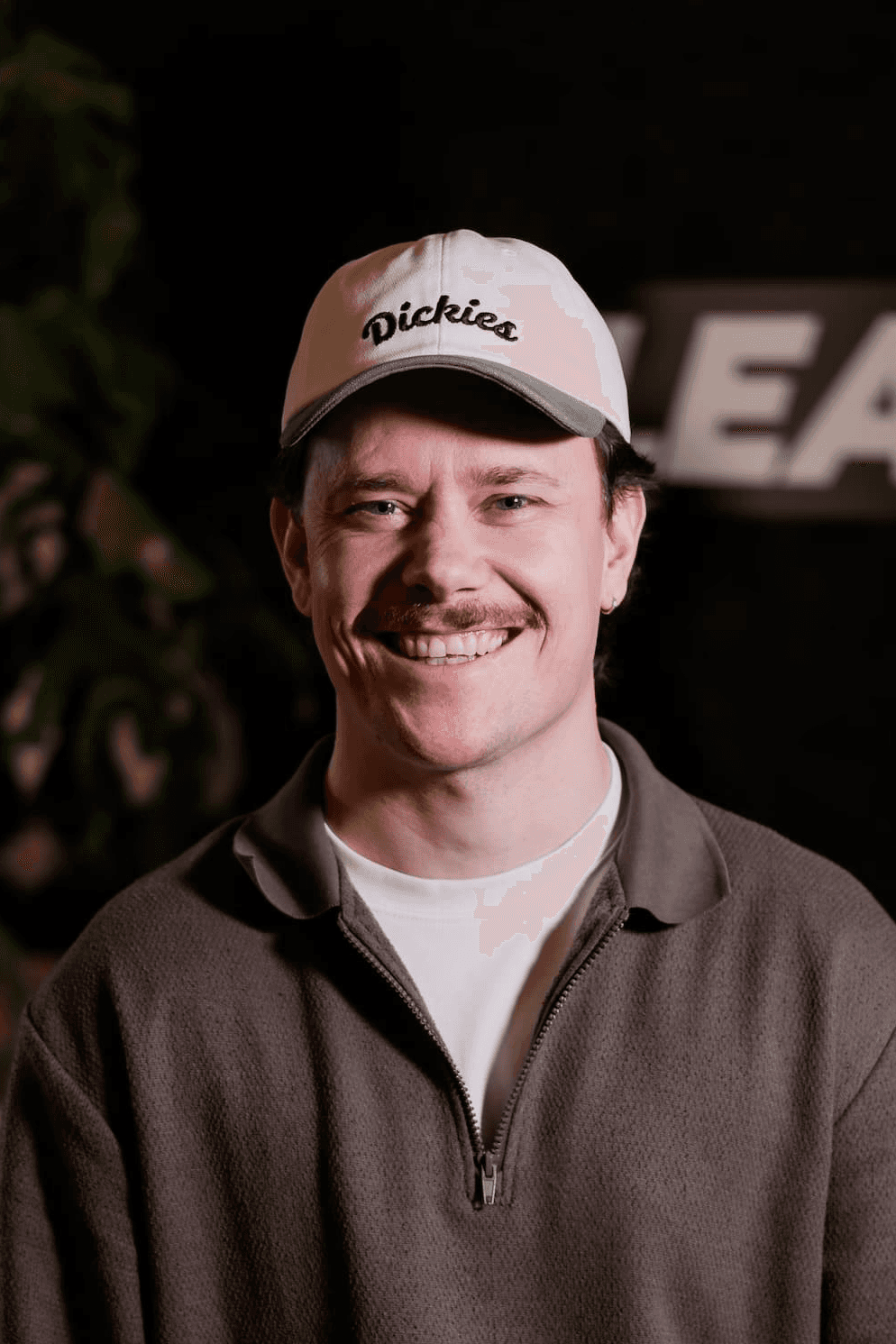 headshot of male in dark background