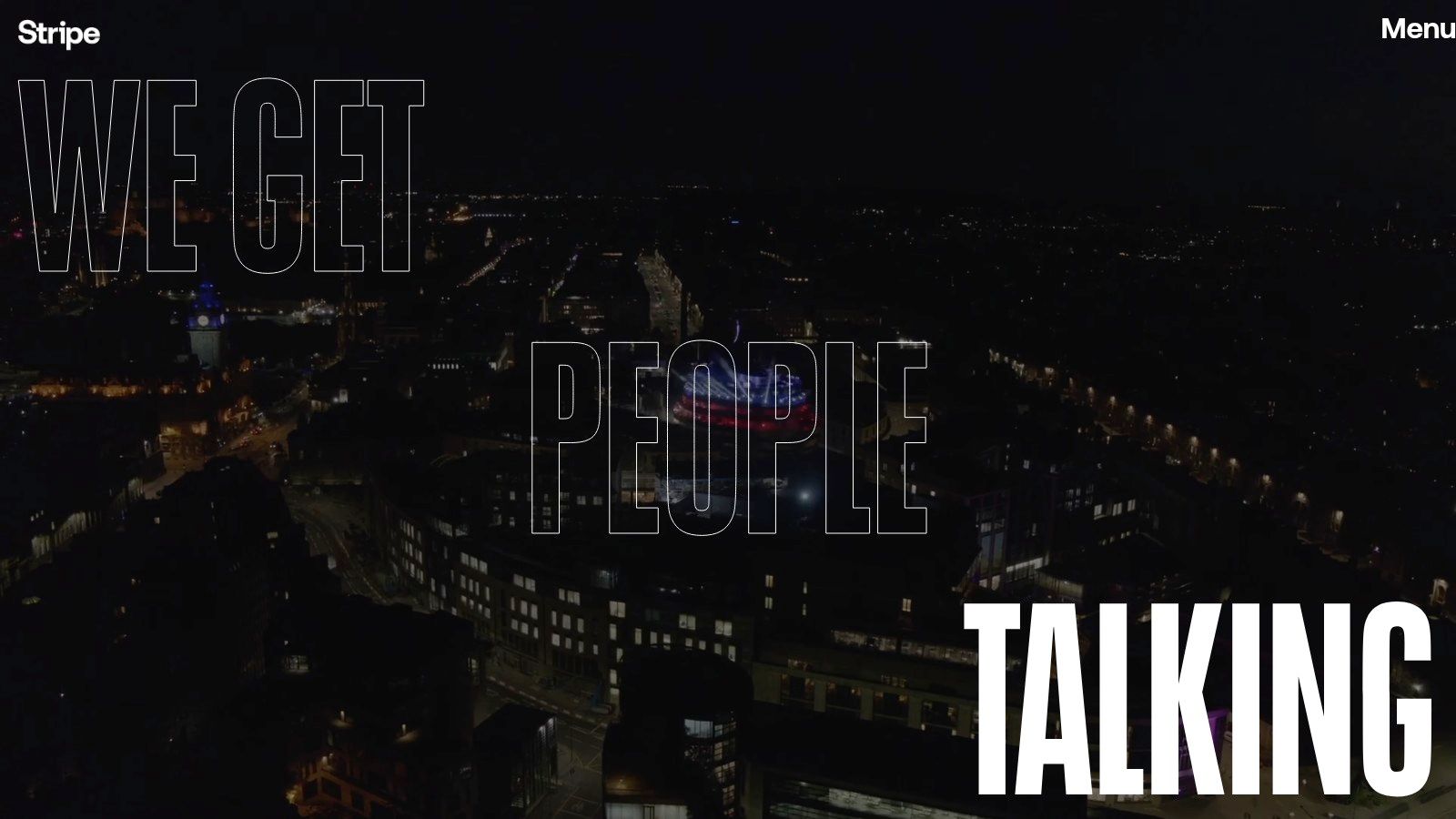 A vibrant city street at night, reflecting the active brand presence Stripe Communications builds.