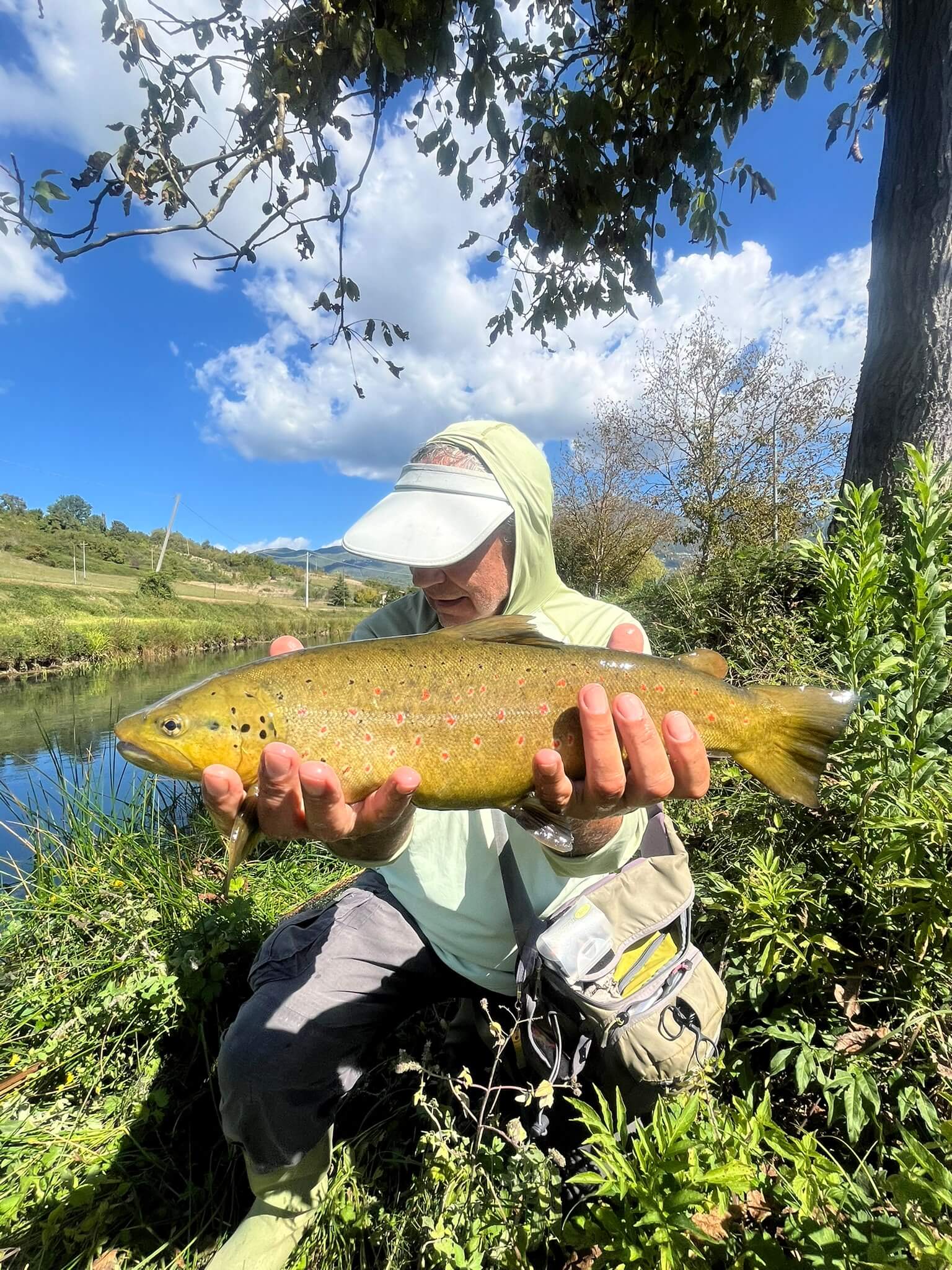 Fly fisherman casting a 3 weight rod on a chalk stream near Rome