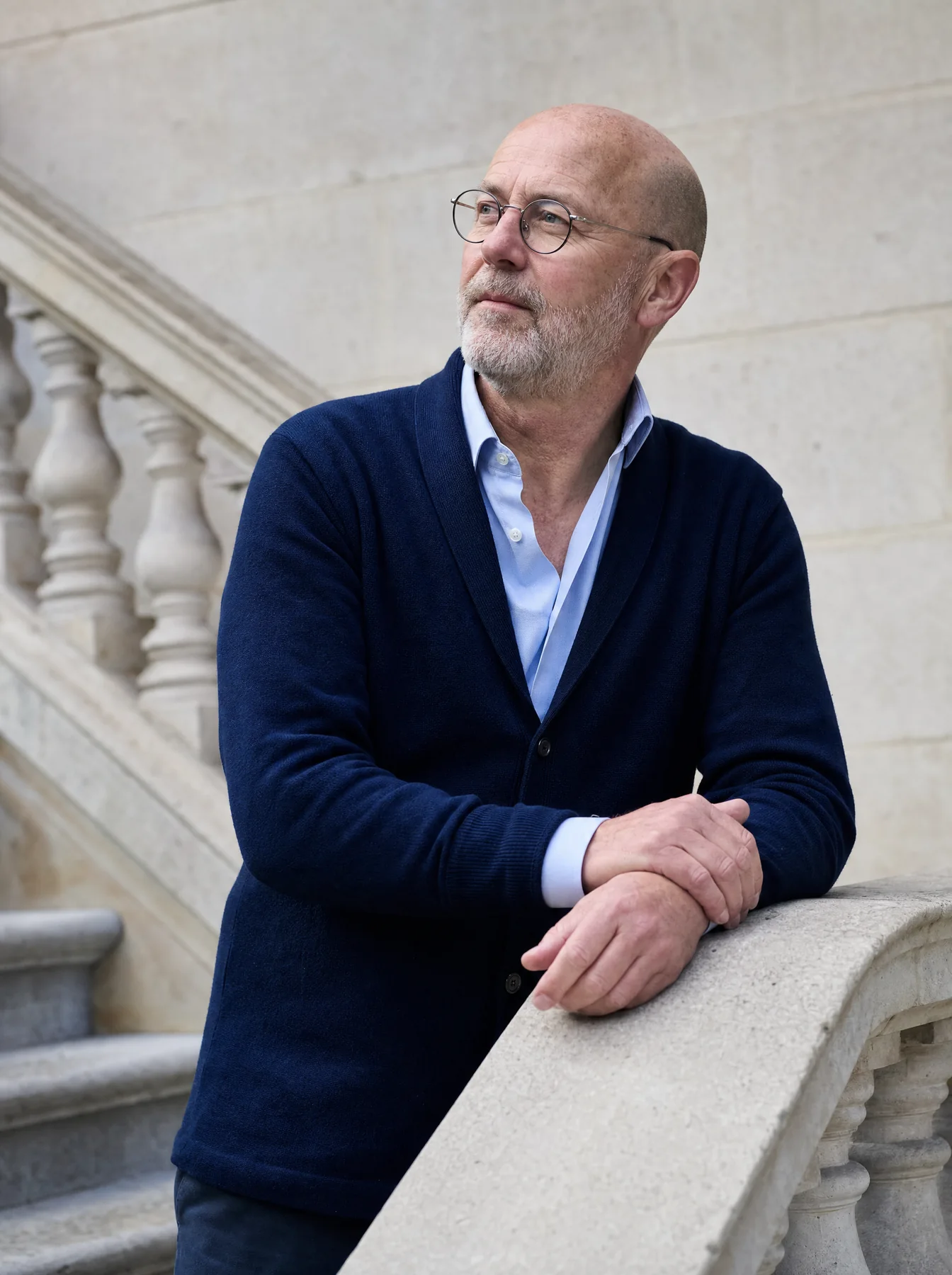 Rob Sinclair, partner, leaning on a stone balustrade