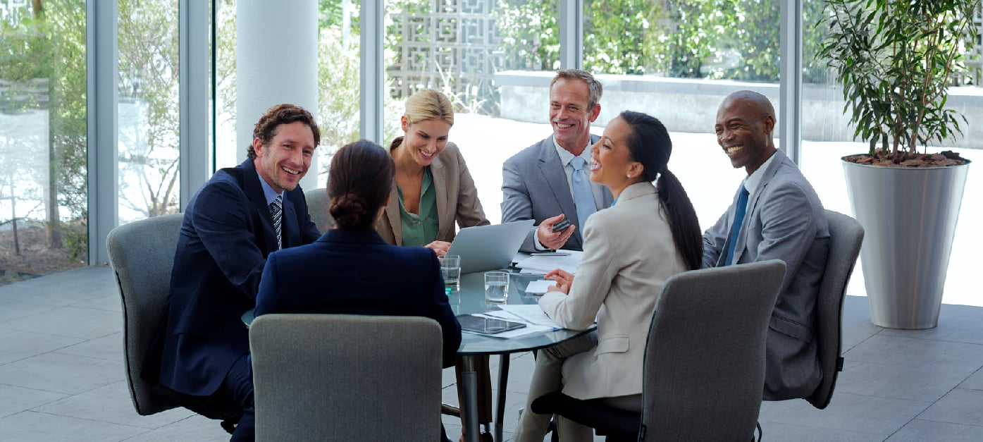 Five Hyland Professionals meeting, two of them are shaking hands.