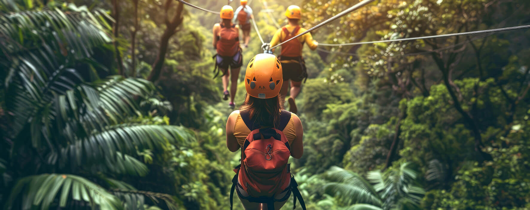 Friends zip-lining together through the Fijian forest 