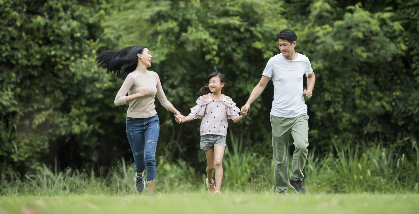 woman holding man and toddler hands during daytime