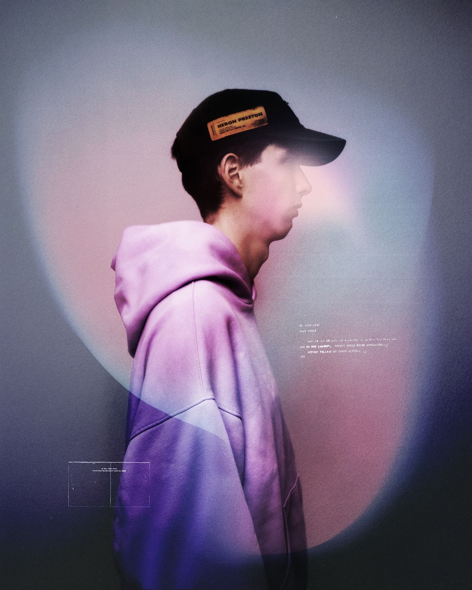 Cryptic in profile wearing a lavender hoodie and cap