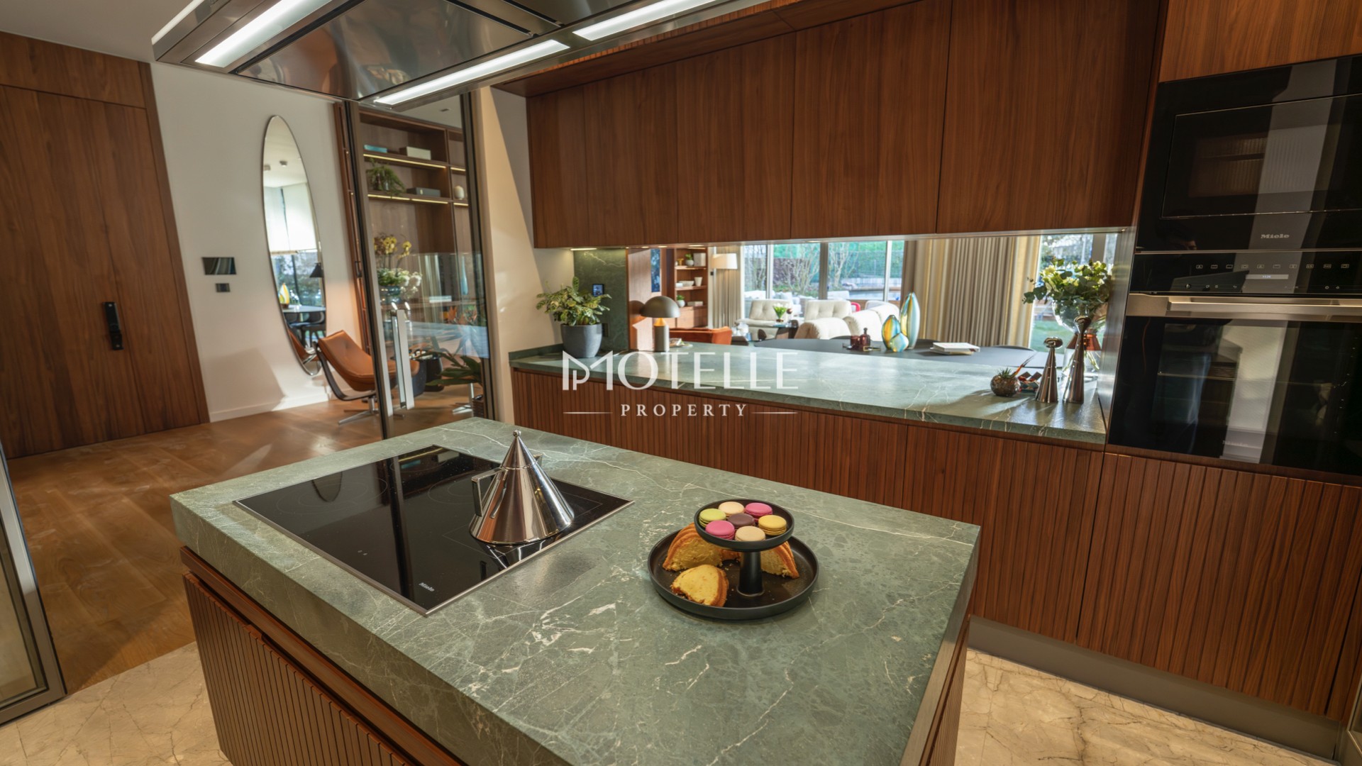 Open-plan luxury residence in Etiler featuring a modern designer kitchen, elegant dining area, wooden flooring and spacious living room.