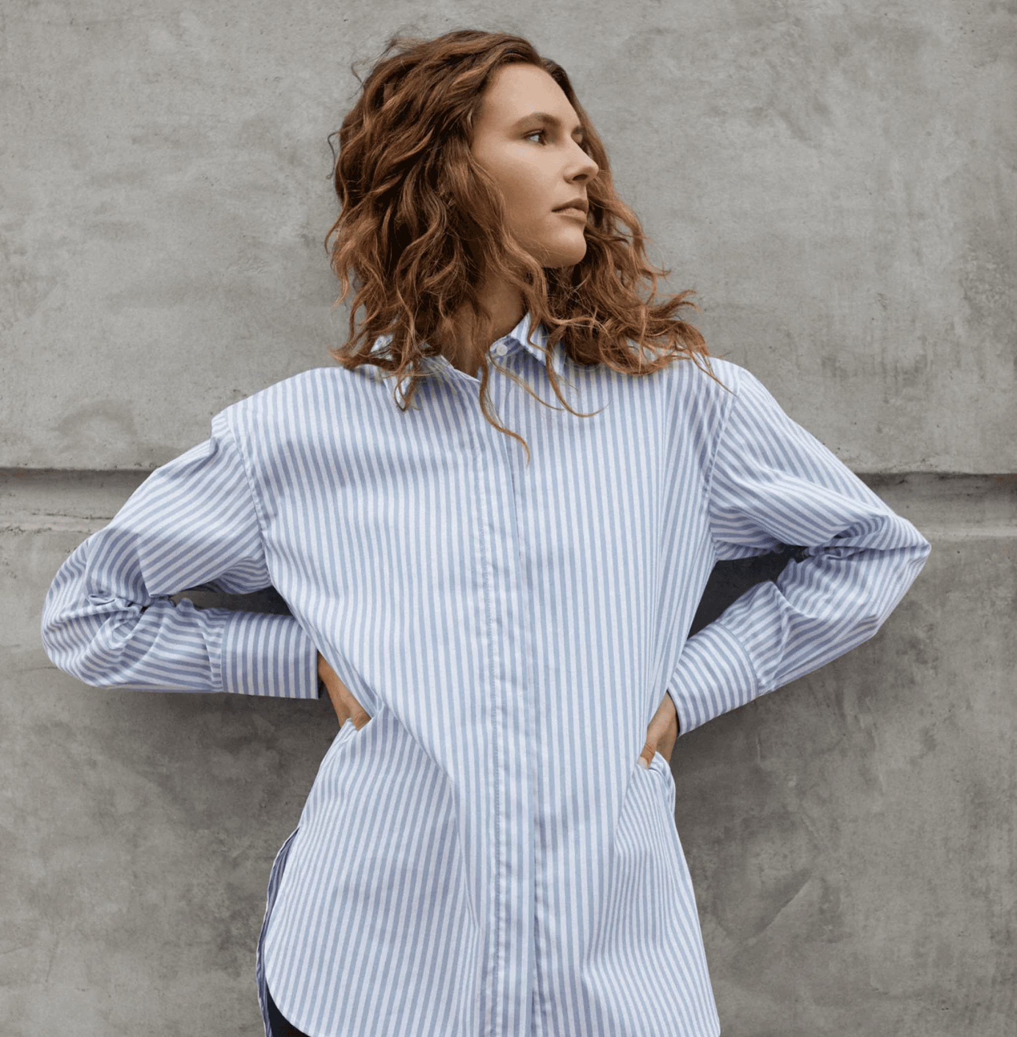 Woman wearing a Kit and Ace striped shirt 
