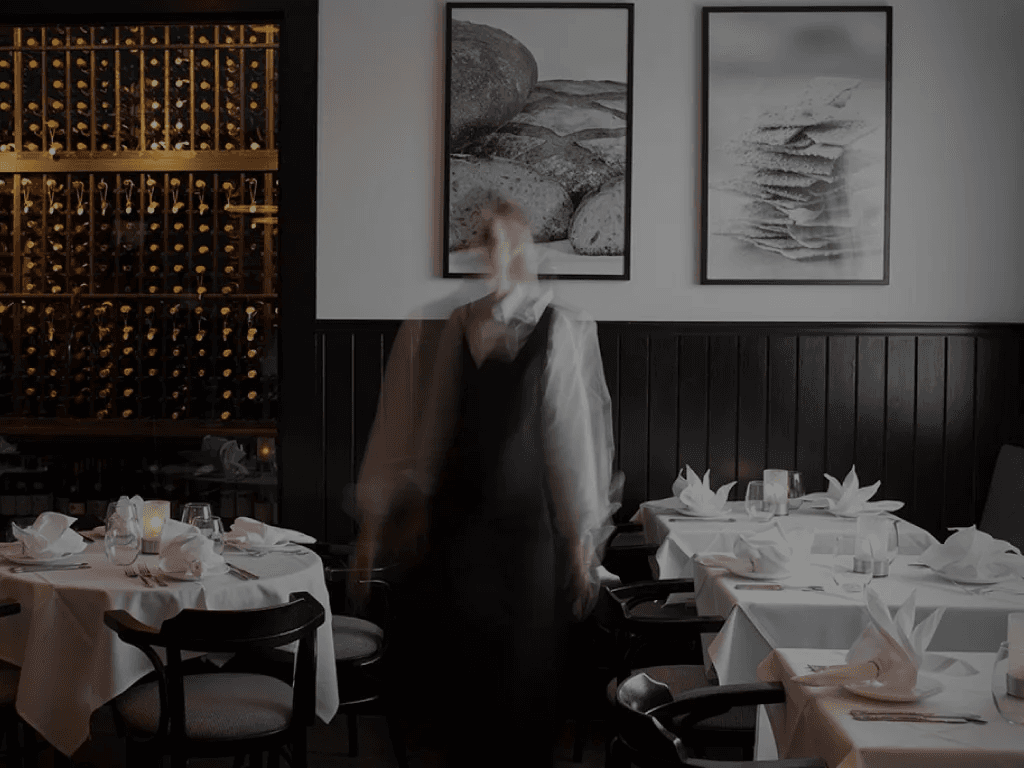 The interior of the dining room in Pain d'Avignon Hyannis showing the dinner table setup