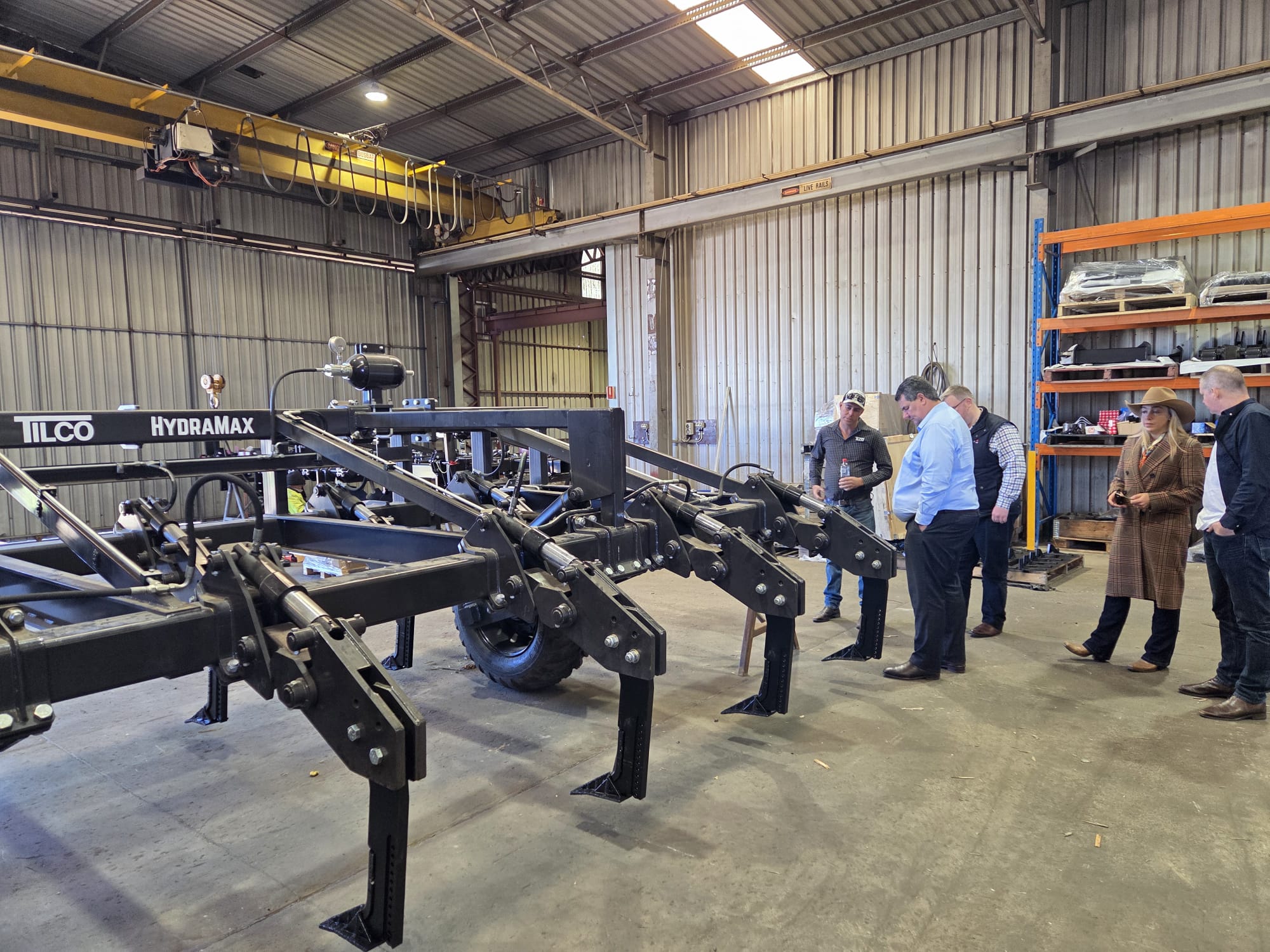 TIQ representatives and Global Ag Solutions staff inspecting a Tilco HydraMax deep ripper on the workshop floor