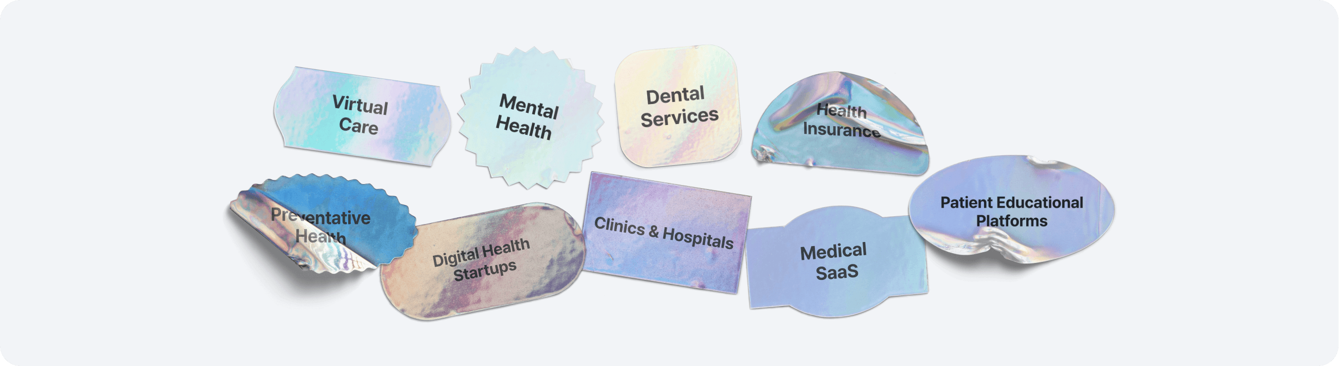 Close-up of two smiling friends with freckles, bright makeup, on a light blue background—joyful, inclusive brand portrait.