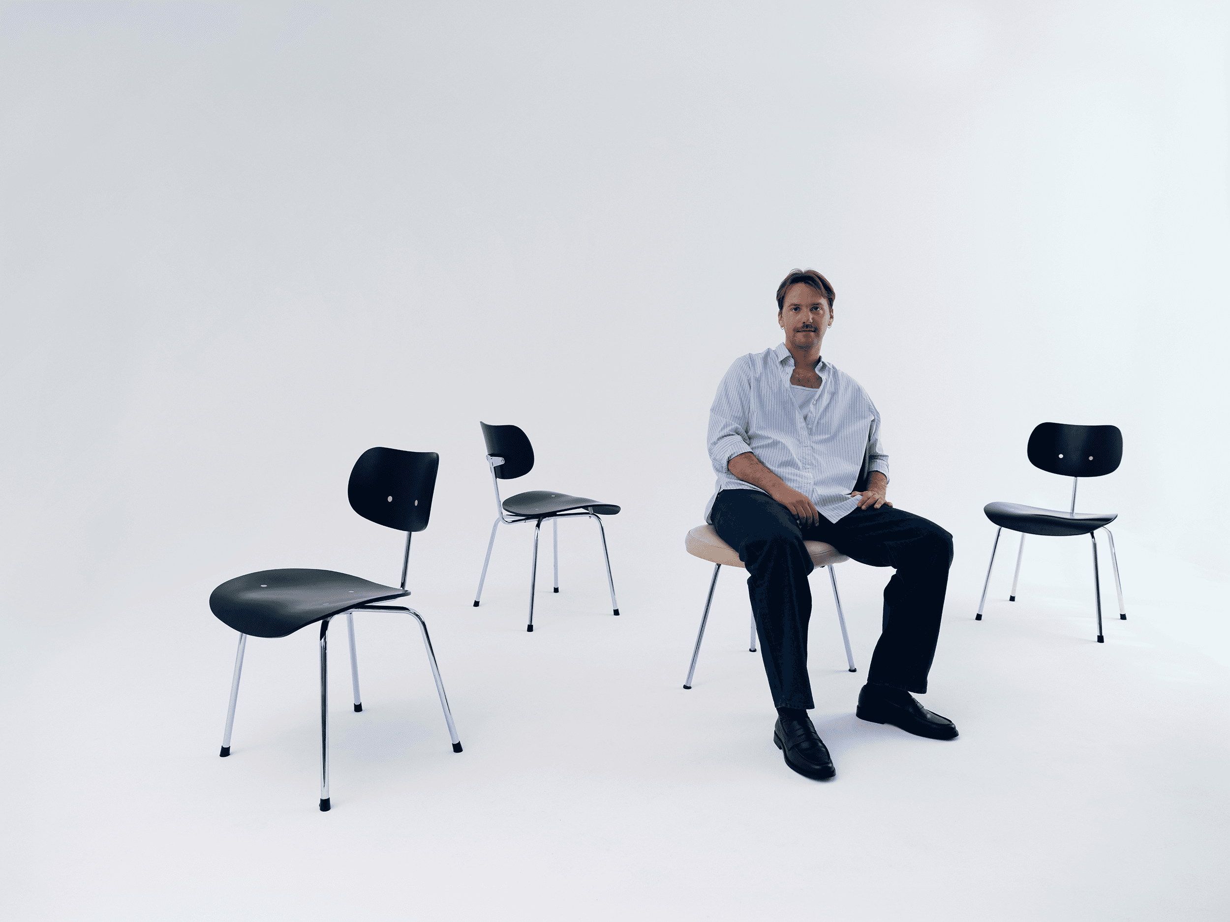 Creative lead Mike Gajer sitting on a balance ball in a clean studio environment, reflecting the balance between strategy and creativity. Photographer: Ruben Riermeier