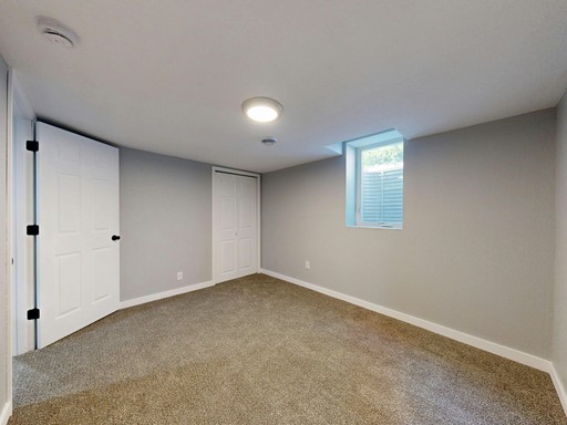 gray sofa chair beside window