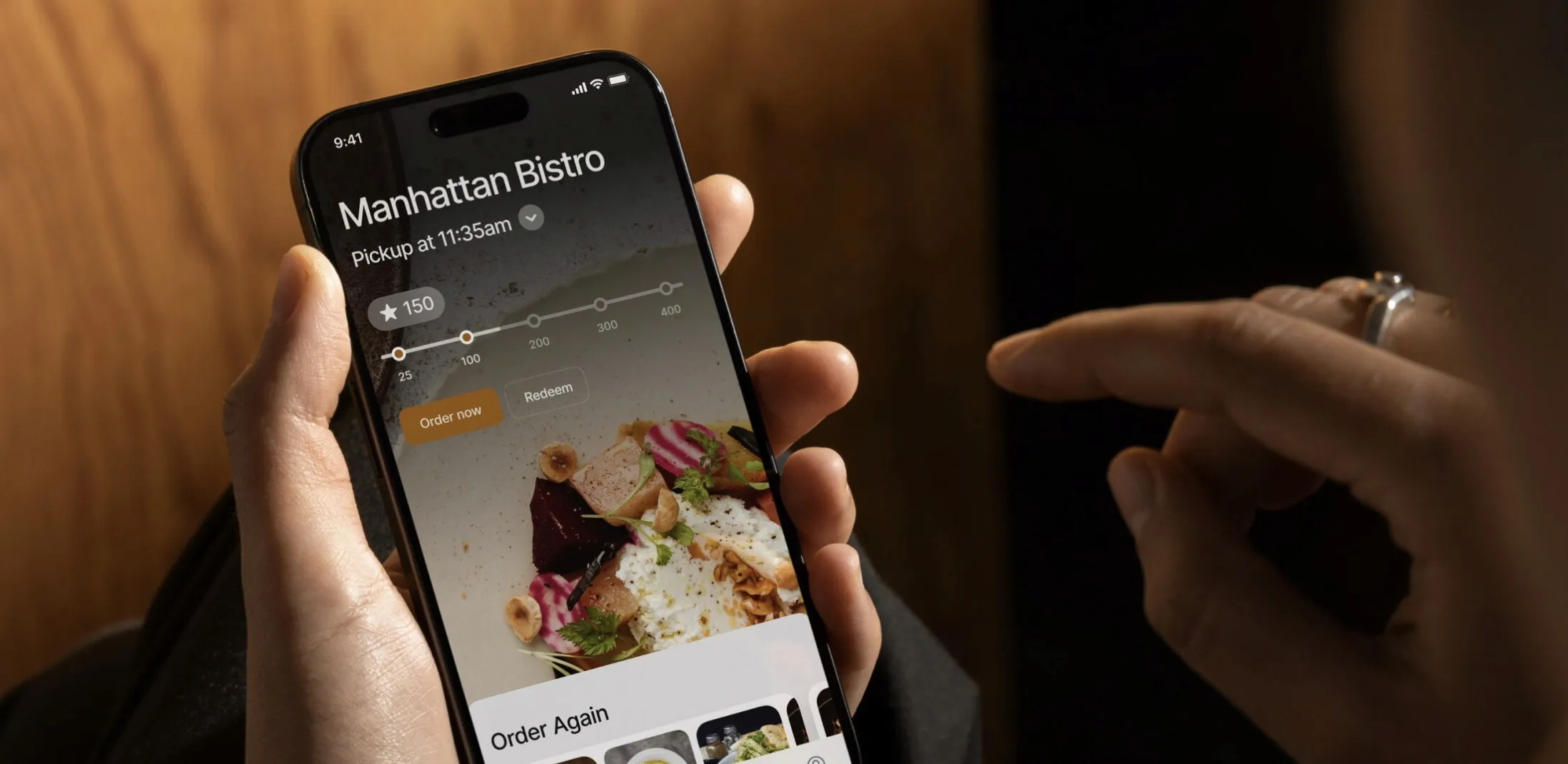 Hand holding an iPhone with a restaurant menu opened