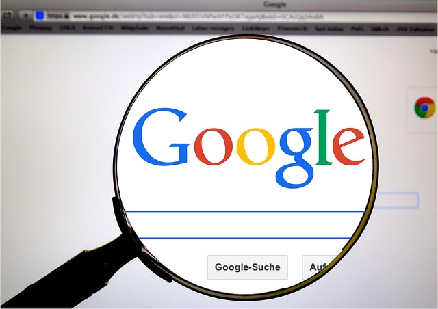 Magnifying glass zooming in on the Google logo