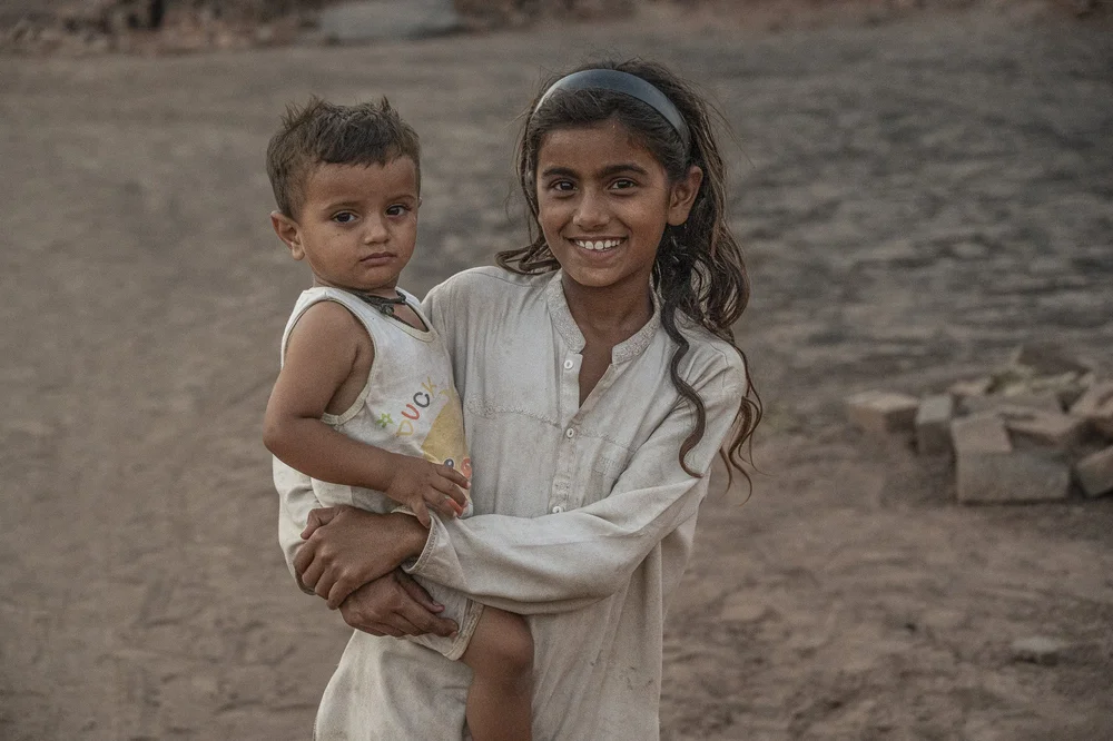 Girl carrying a young child