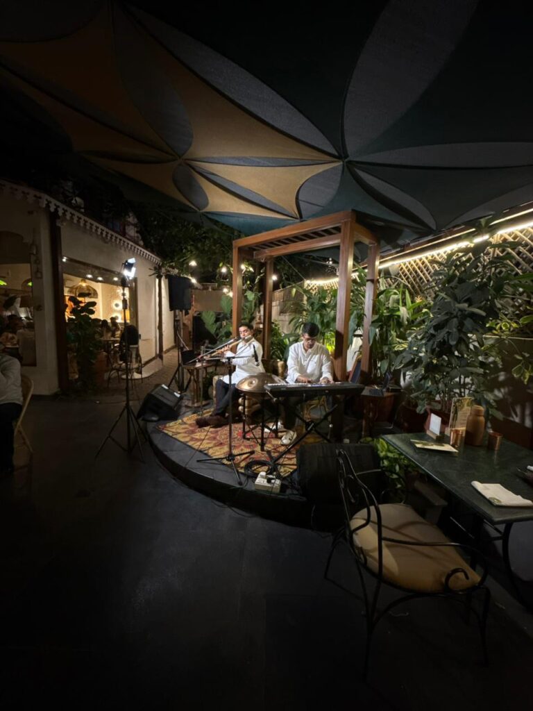 Minimal ambient live music stage setup with handpan and flute at Santé Spa Cuisine Pune