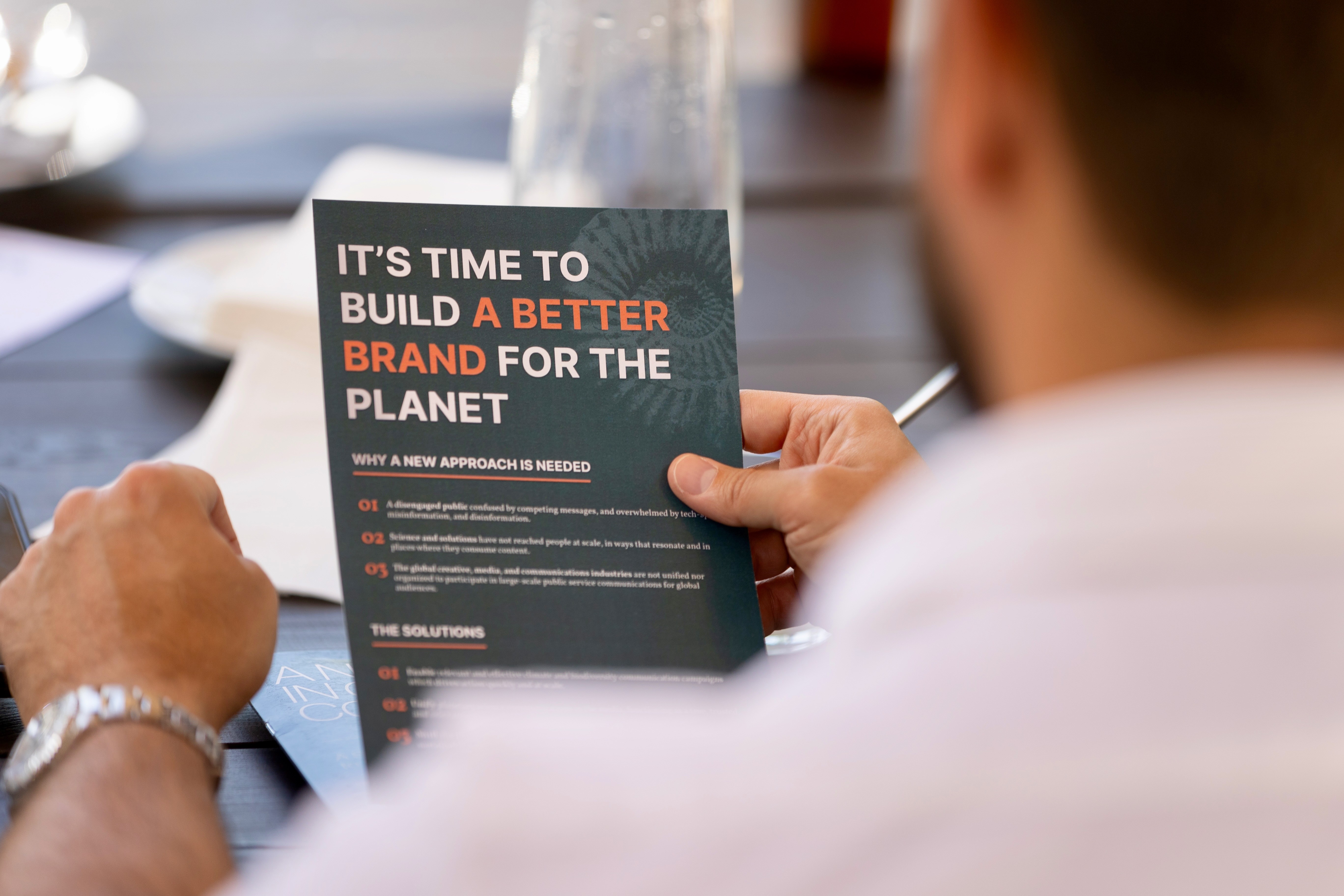 Slideshow Image - man Reading an EPIC New Zero World campaign leaflet