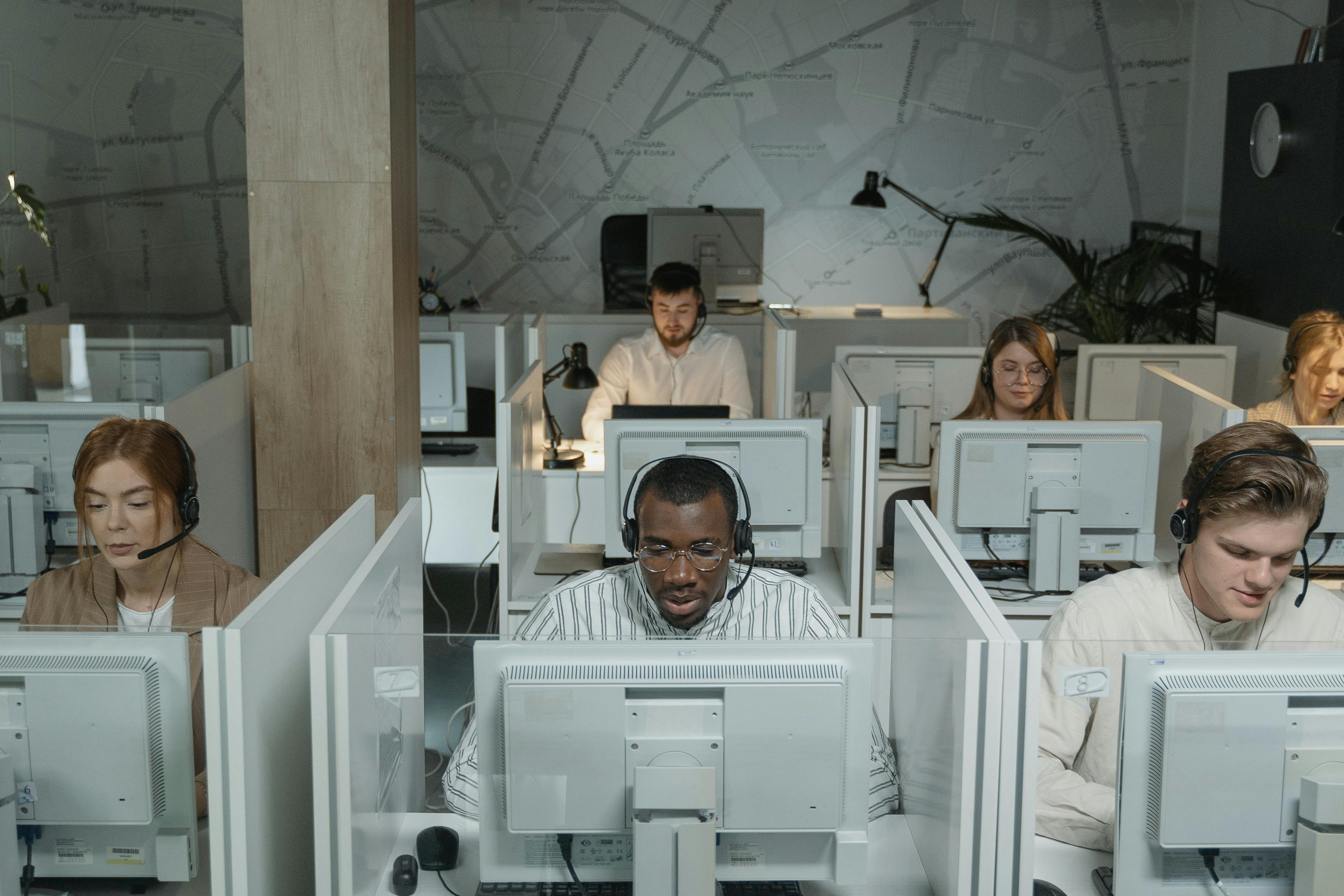 Wide shot of a call center with multiple agents at their desks