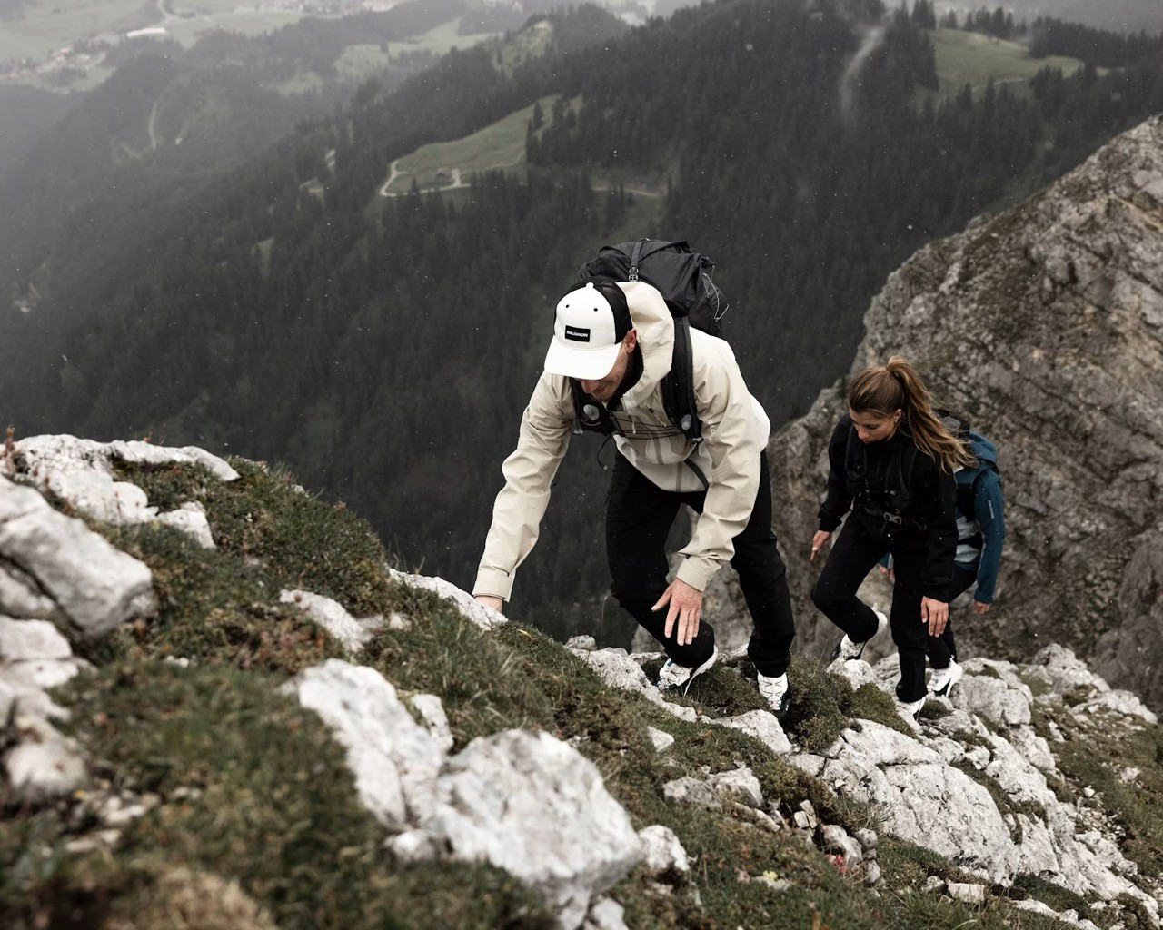Hikers climbing on rocks in the mountains