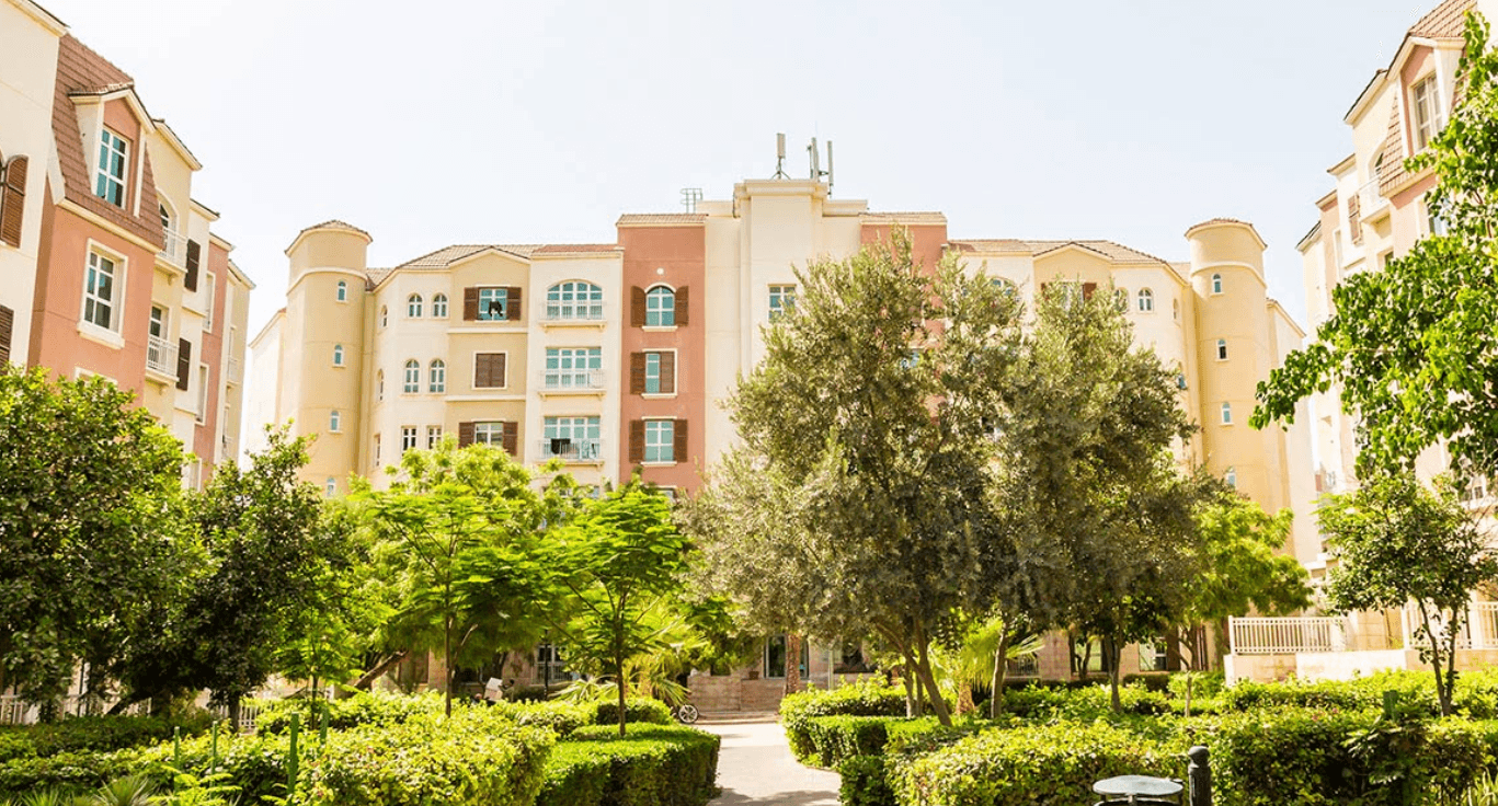 A residential area featuring trees and buildings, showcasing a peaceful suburban environment.