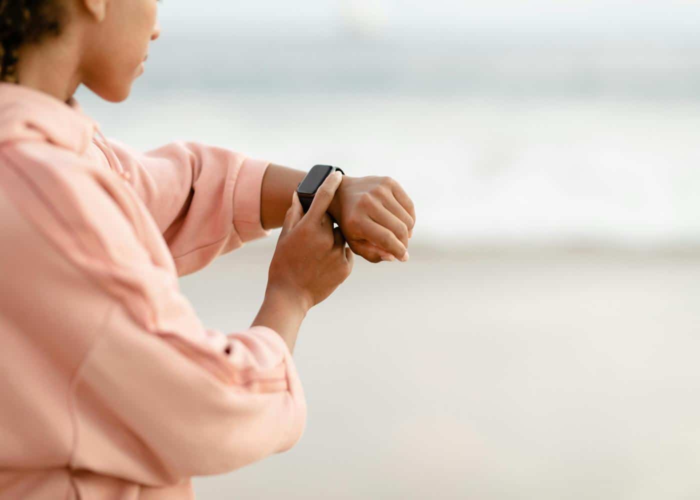 Woman outdoors looking at Apple Watch