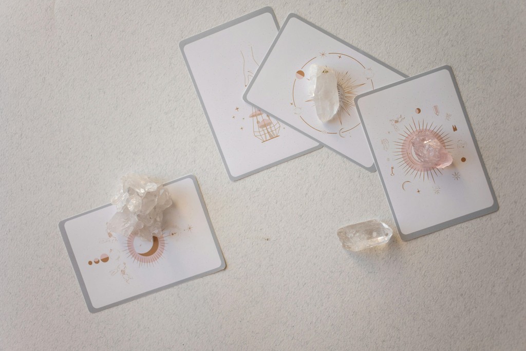 A person lying on a massage table, their face covered with a towel, bathed in warm golden light. The setting exudes relaxation and comfort.